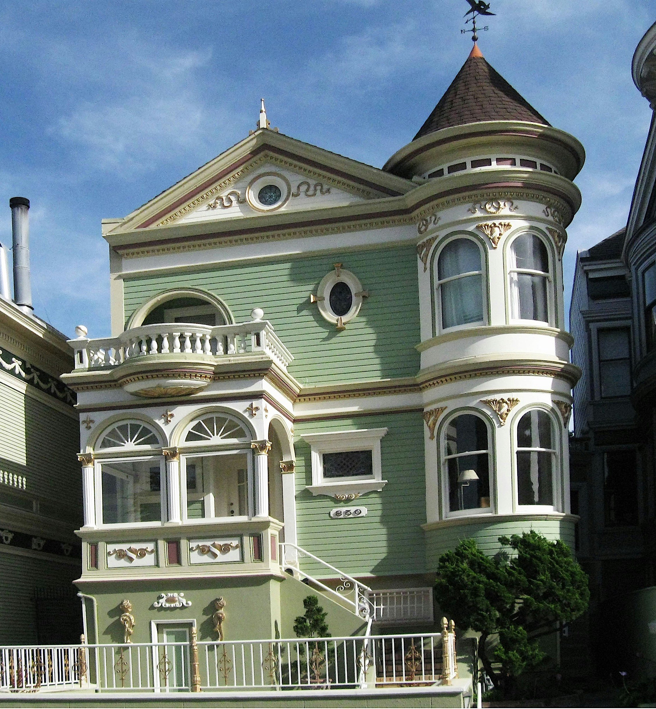 Ornate Queen Anne Victorian home showing multi-color period-appropriate exterior paint scheme