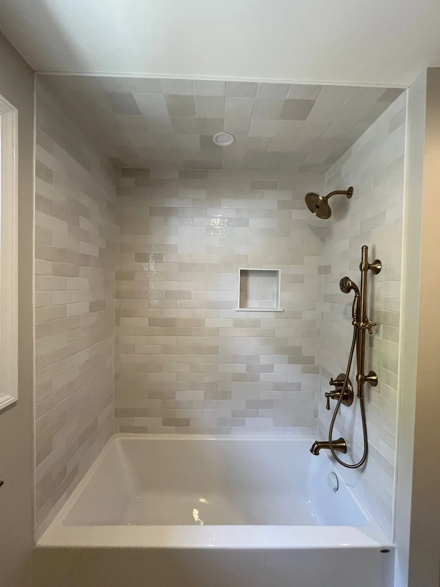 Tub surround with zellige tile and brass fixtures bathroom remodel North Shore MA