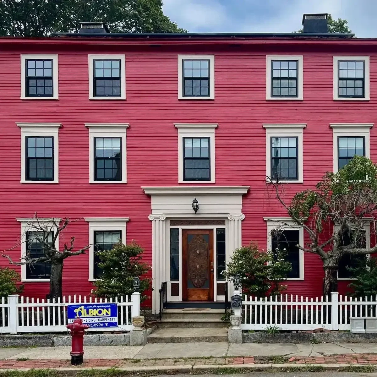 a three story federal house with cream trim and ornate door in newburyport ma