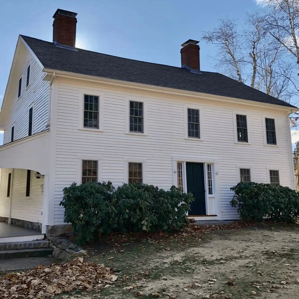 a white farmhouse in west newbury with side porch