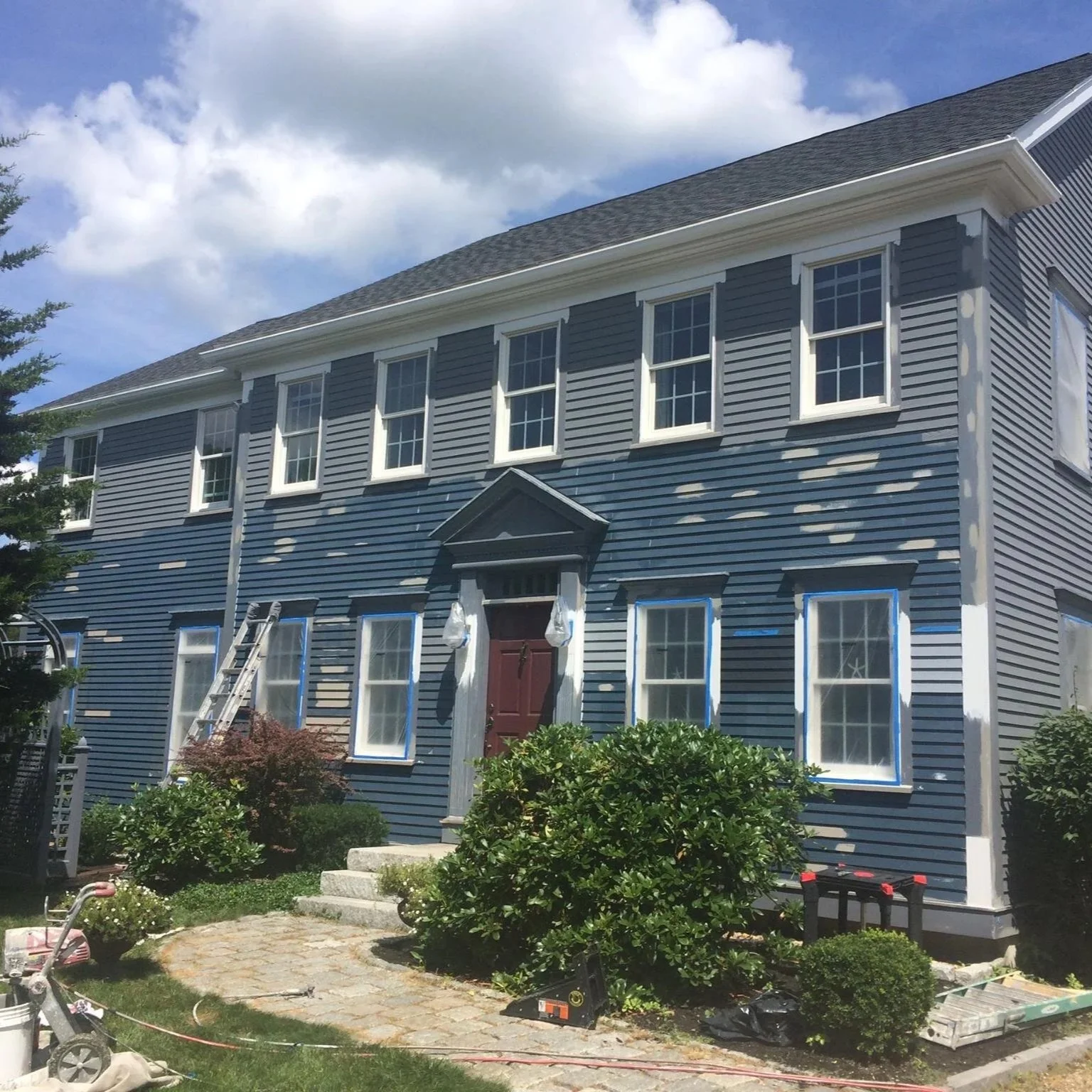 In process exterior painting Greek Revival waterfront home North Shore MA