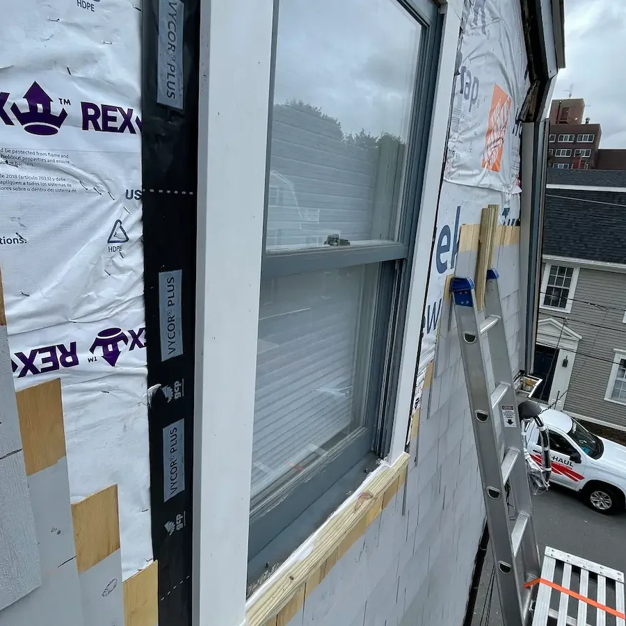 Window surround and trim carpentry detail during exterior restoration, North Shore MA