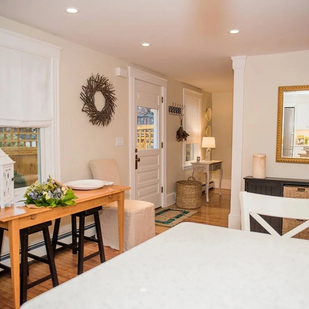 Interior painting of a bright dining room with white trim, neutral walls, and hardwood floors — North Shore, MA