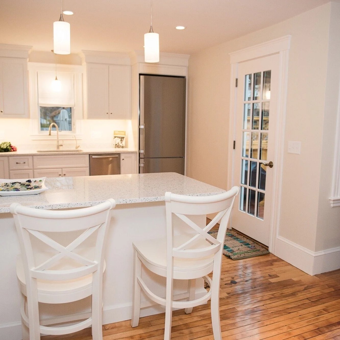Interior painting of a bedroom with white built-in shelves, neutral walls, and hardwood floors — North Shore, MA