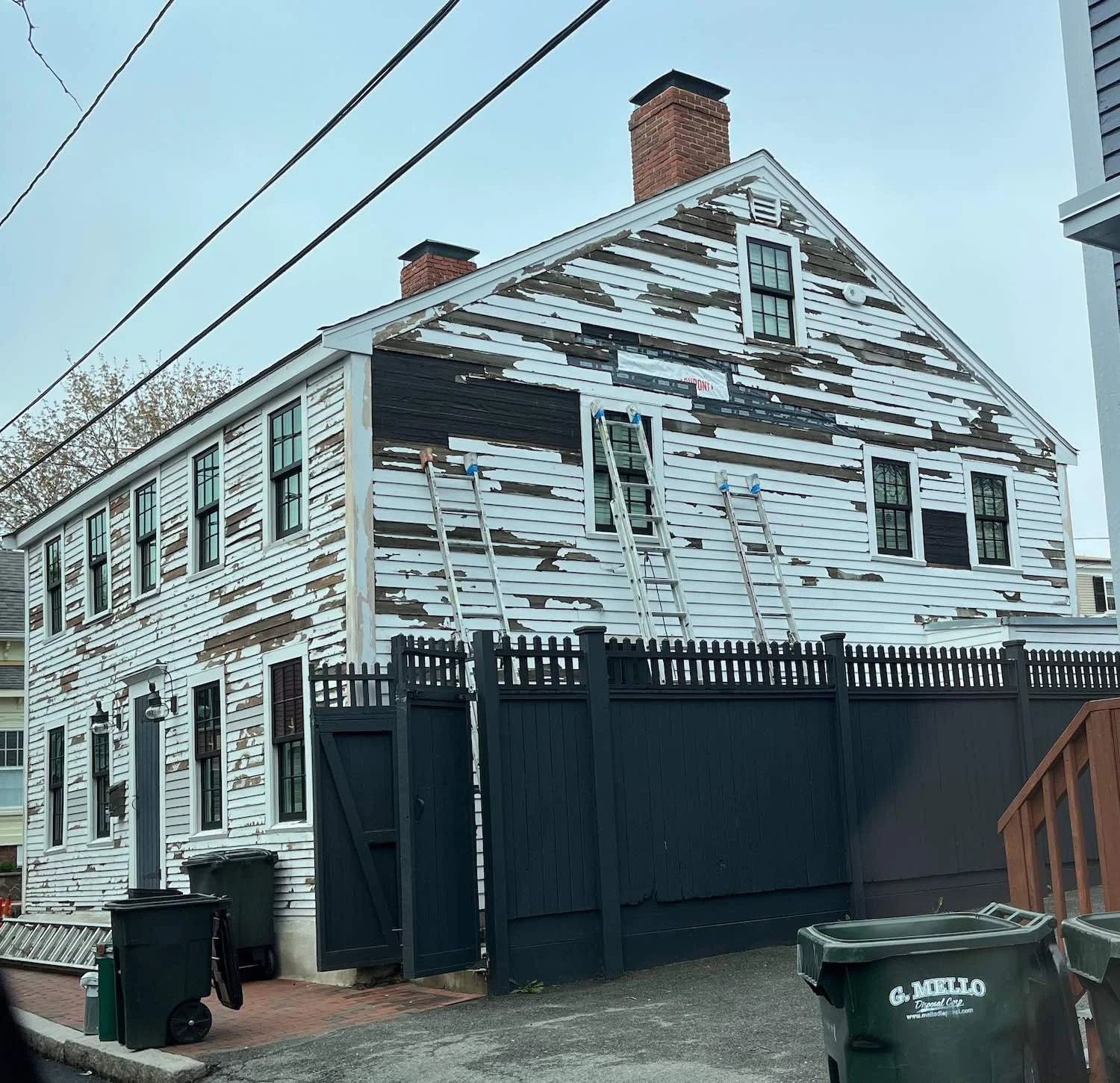 Severely deteriorated exterior paint requiring full scraping preparation on a historic home in Newburyport MA
