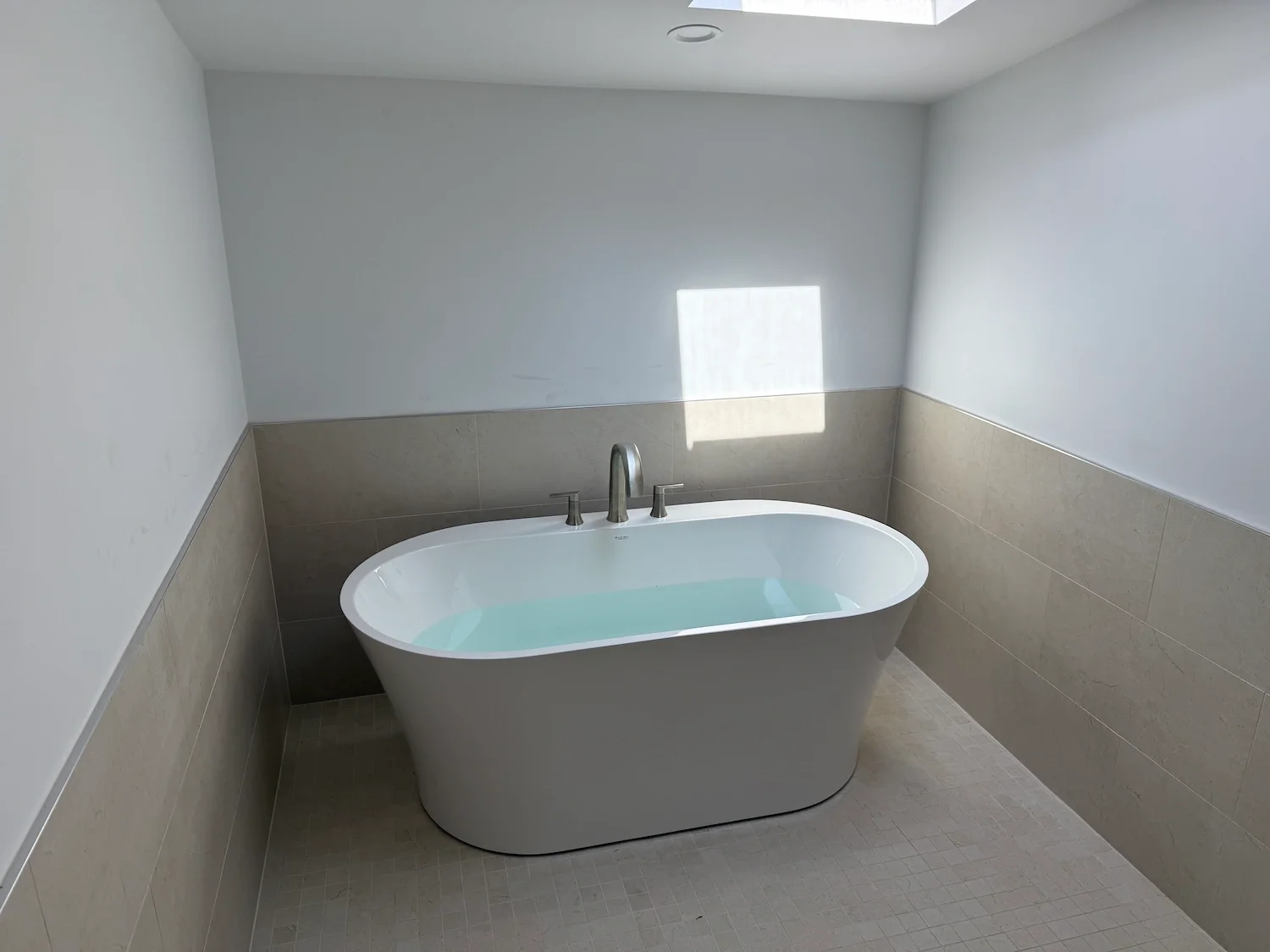 Freestanding soaking tub with skylight bathroom remodel North Shore MA