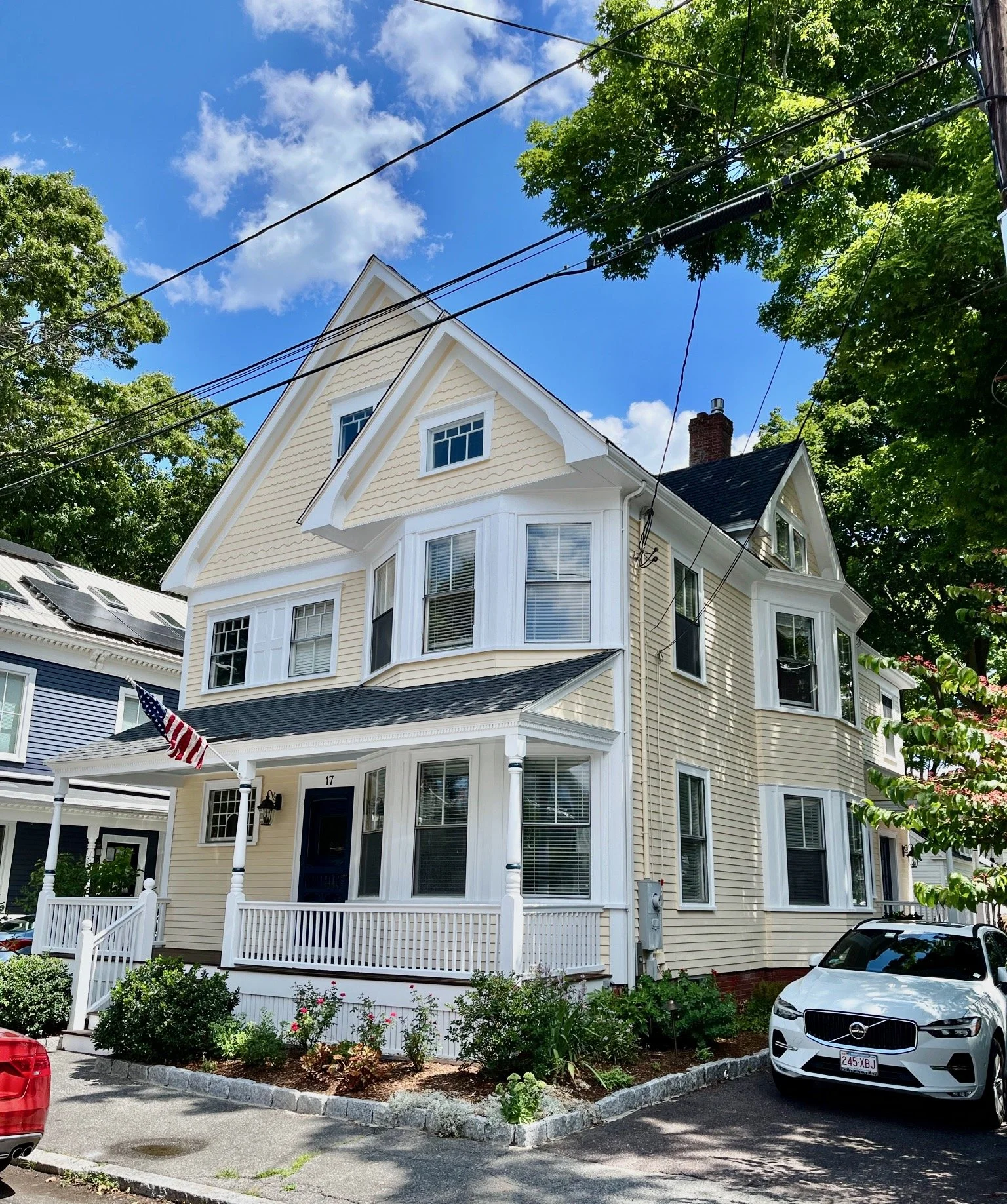 Restored Victorian home exterior with yellow clapboard siding and white trim in Newburyport MA