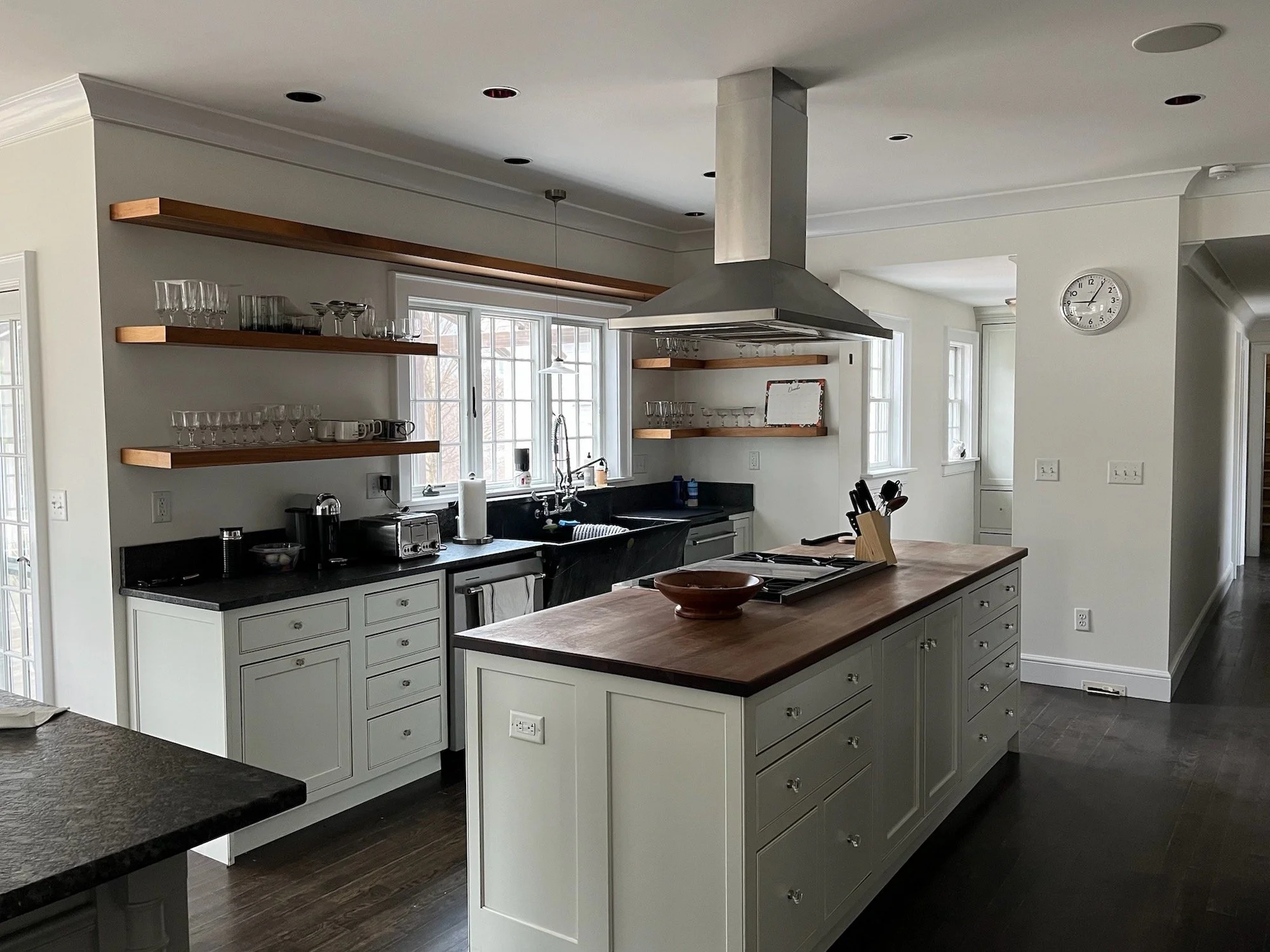 Open plan kitchen renovation with floating shelves, farmhouse sink and butcher block island on the North Shore MA