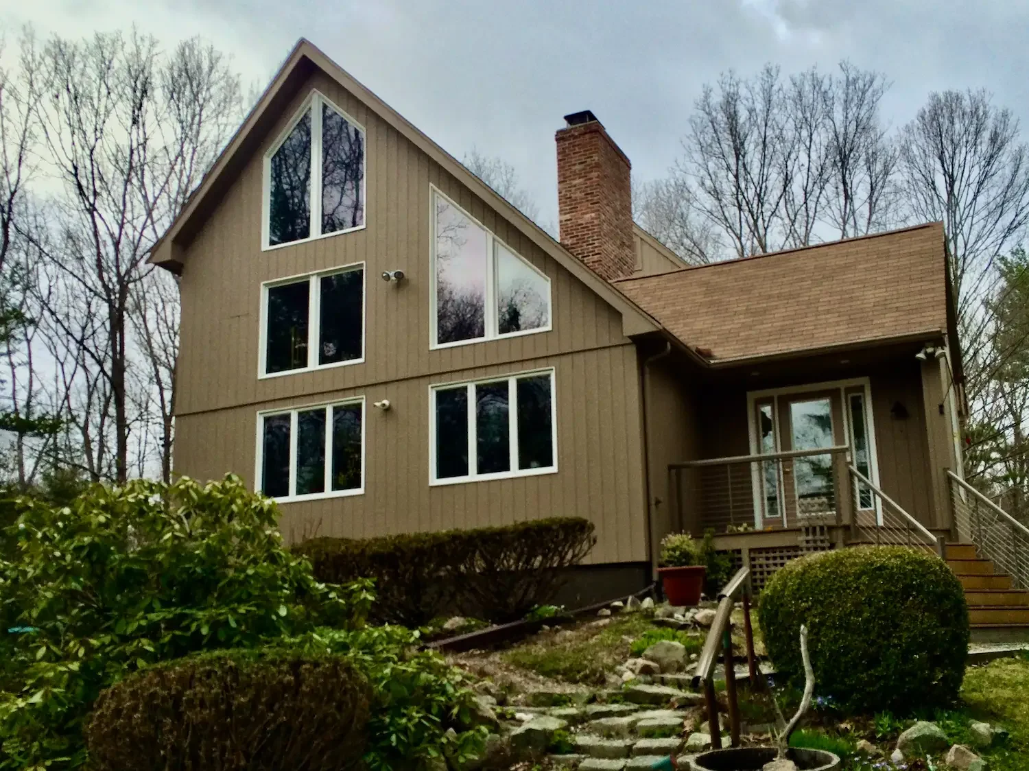 Exterior painting in Newbury MA — contemporary home with board and batten siding by Albion Contracting