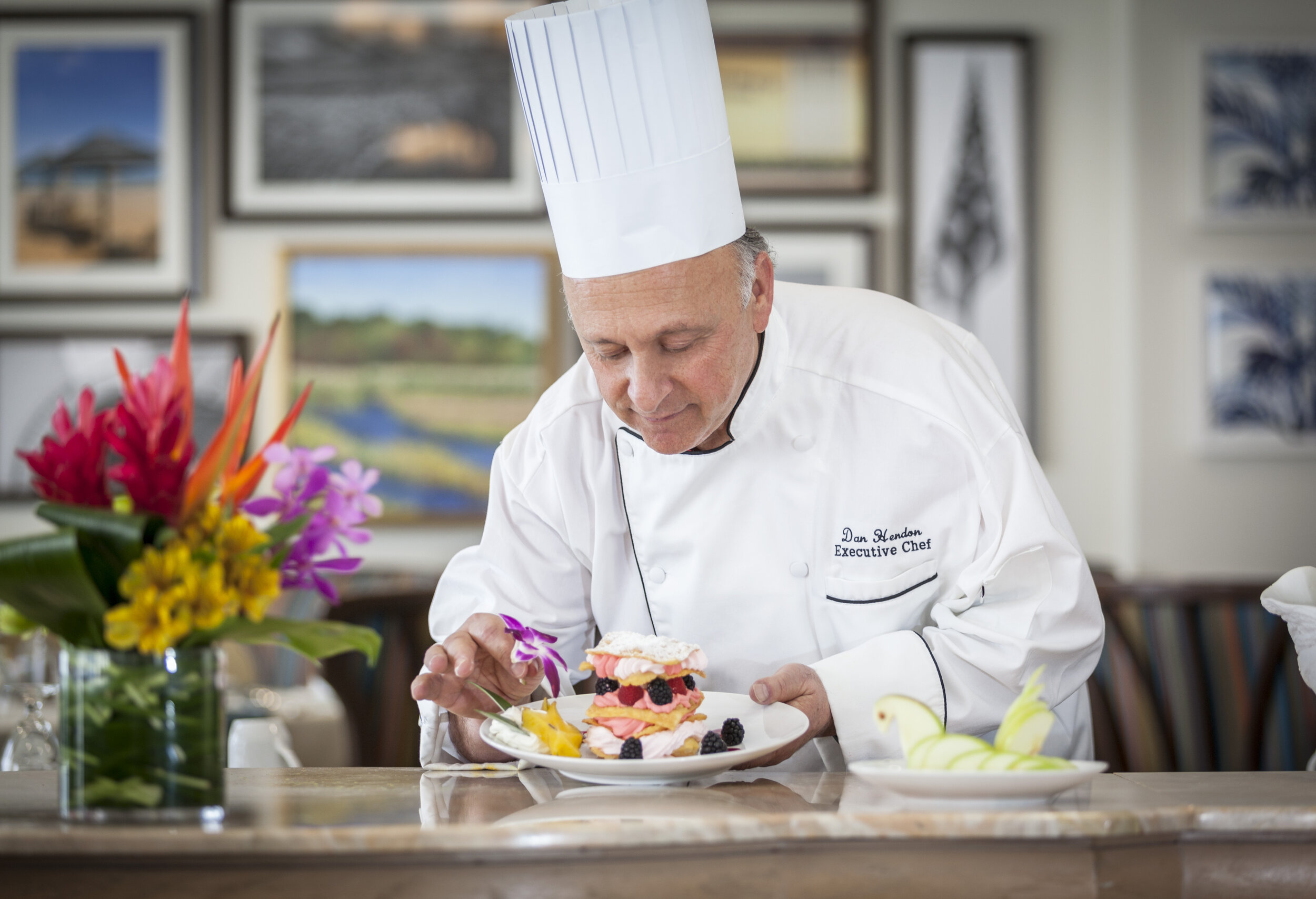 Chef with food, Chef putting final touch on plate,Woodbury & Associates Photography, Woodbury & Associates Photography Stuart Fla.,Woodbury & Associates Photography Senior living photography, Senior Living Photography, Senior Living communities, Fiv