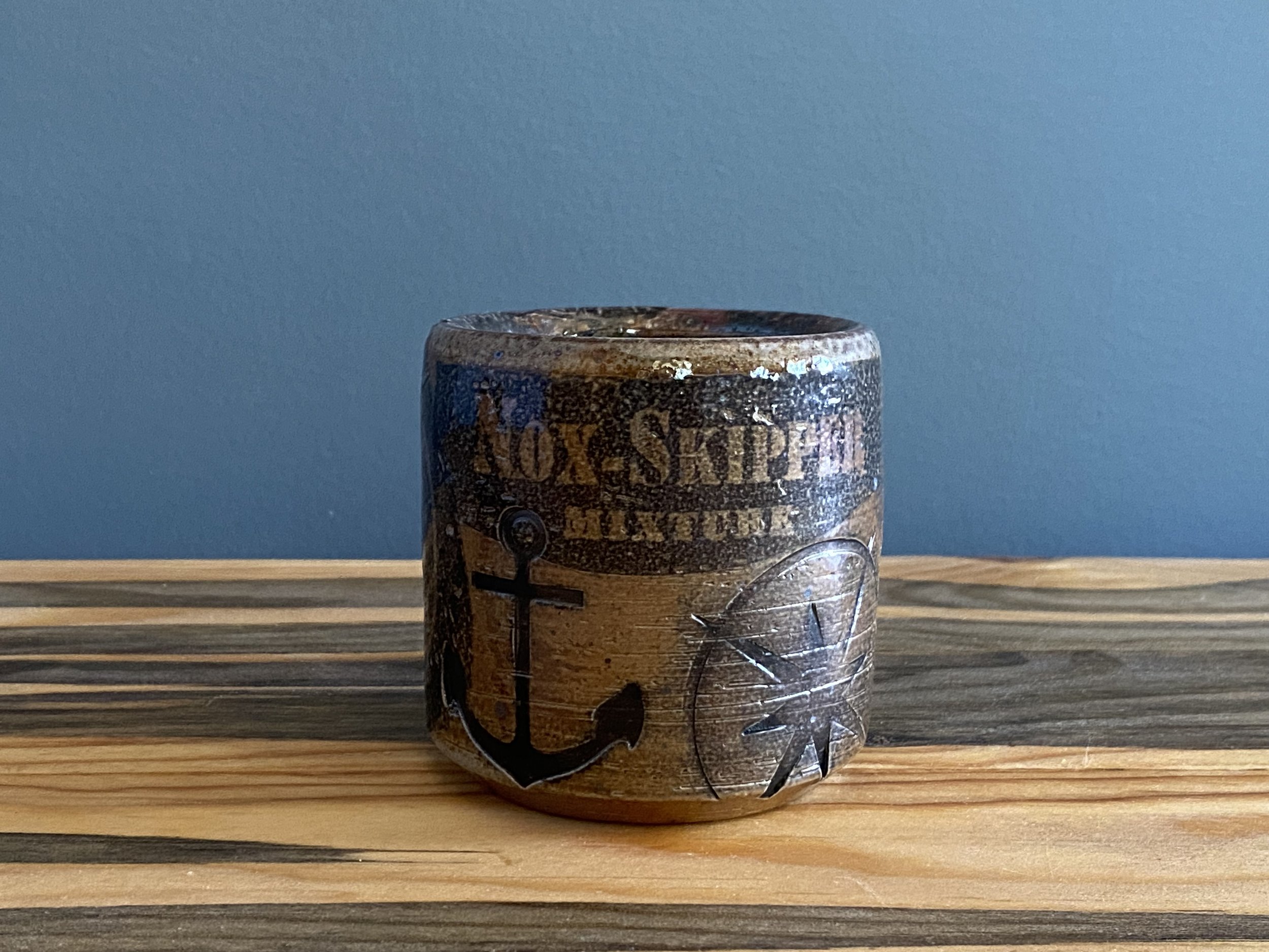 Stoneware cup with handmade monoprint transfers and stamped imagery
