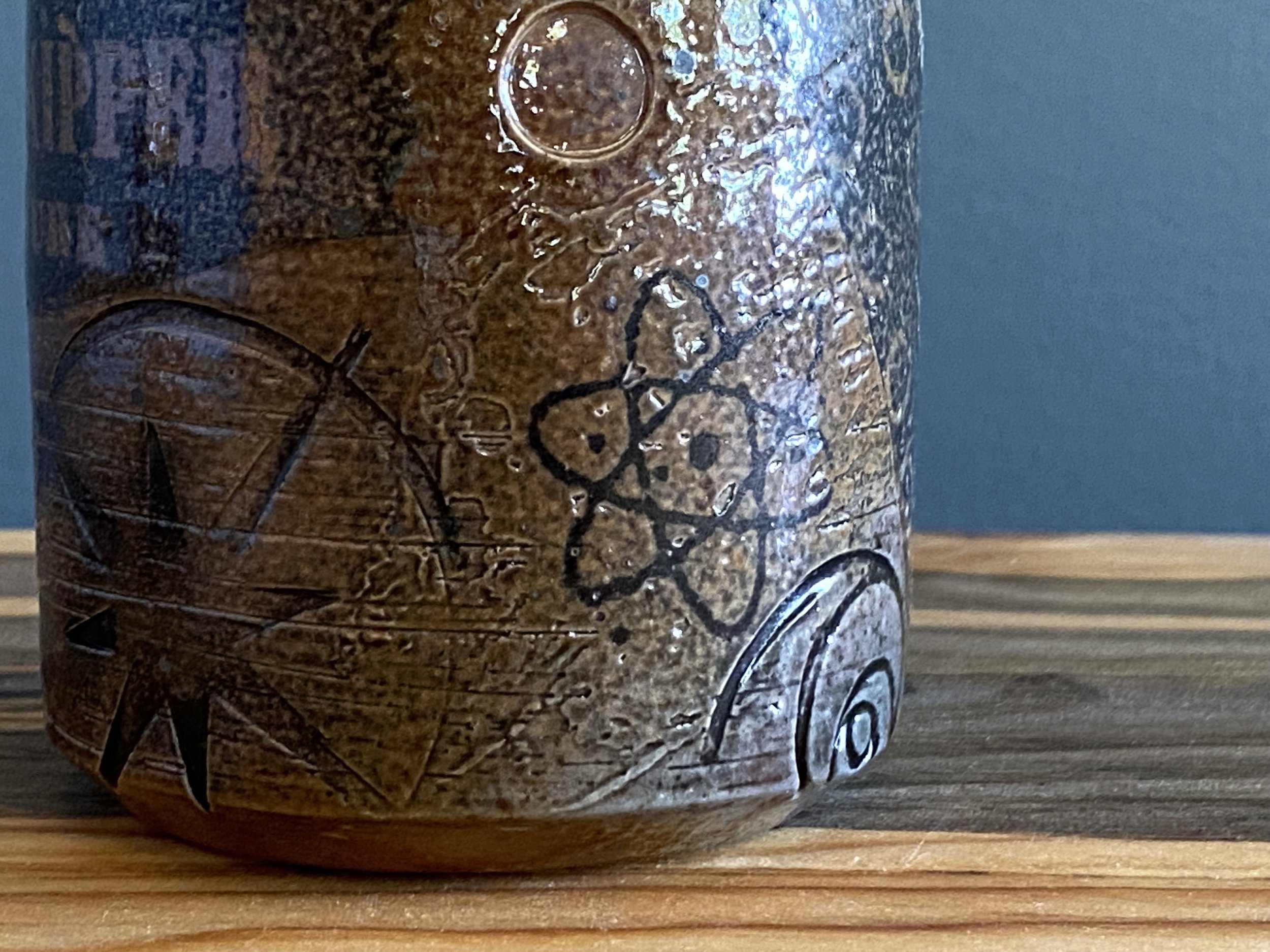Stoneware cup with handmade monoprint transfers and stamped imagery