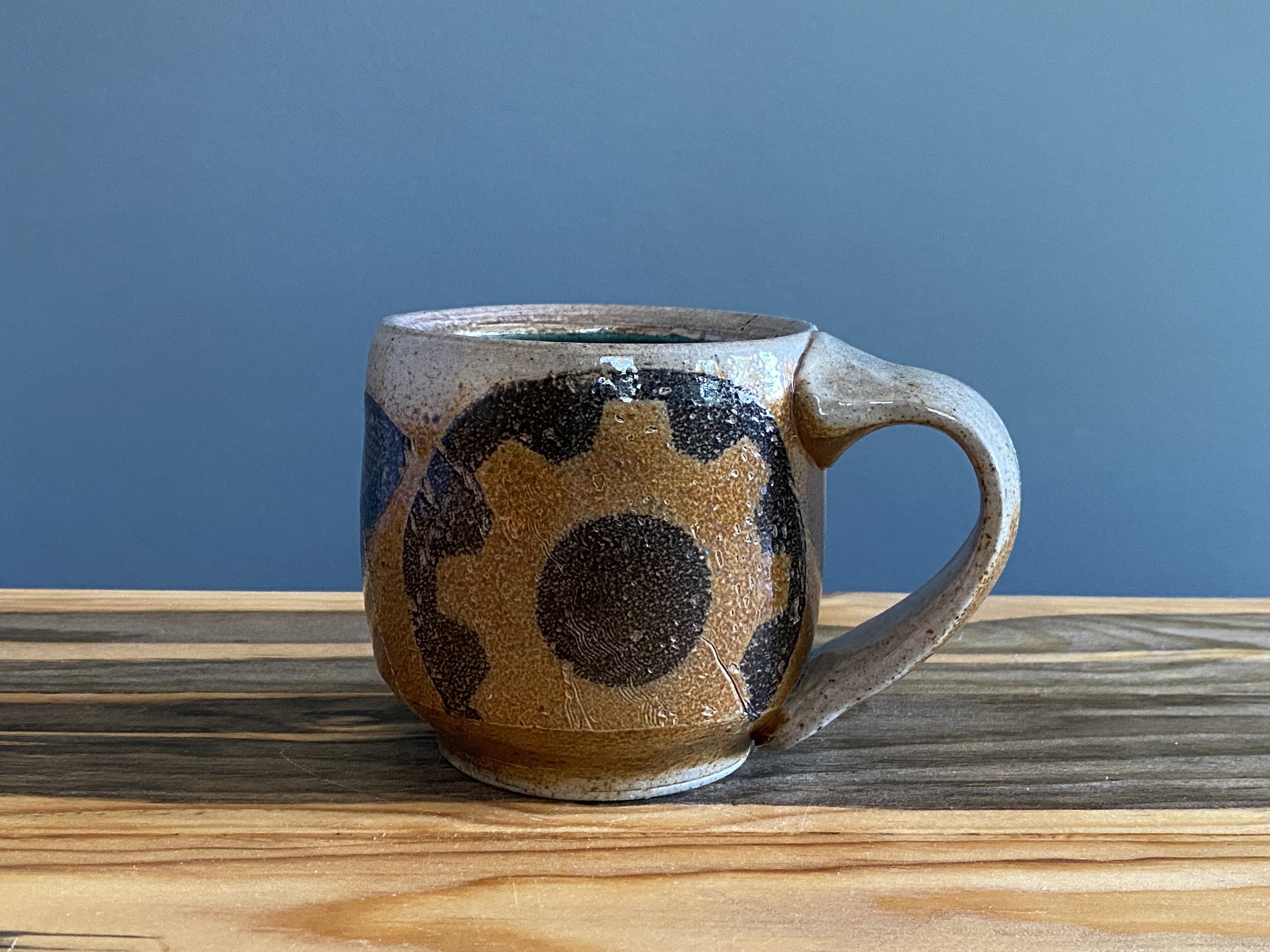 Stoneware mug with handmade monoprint transfers
