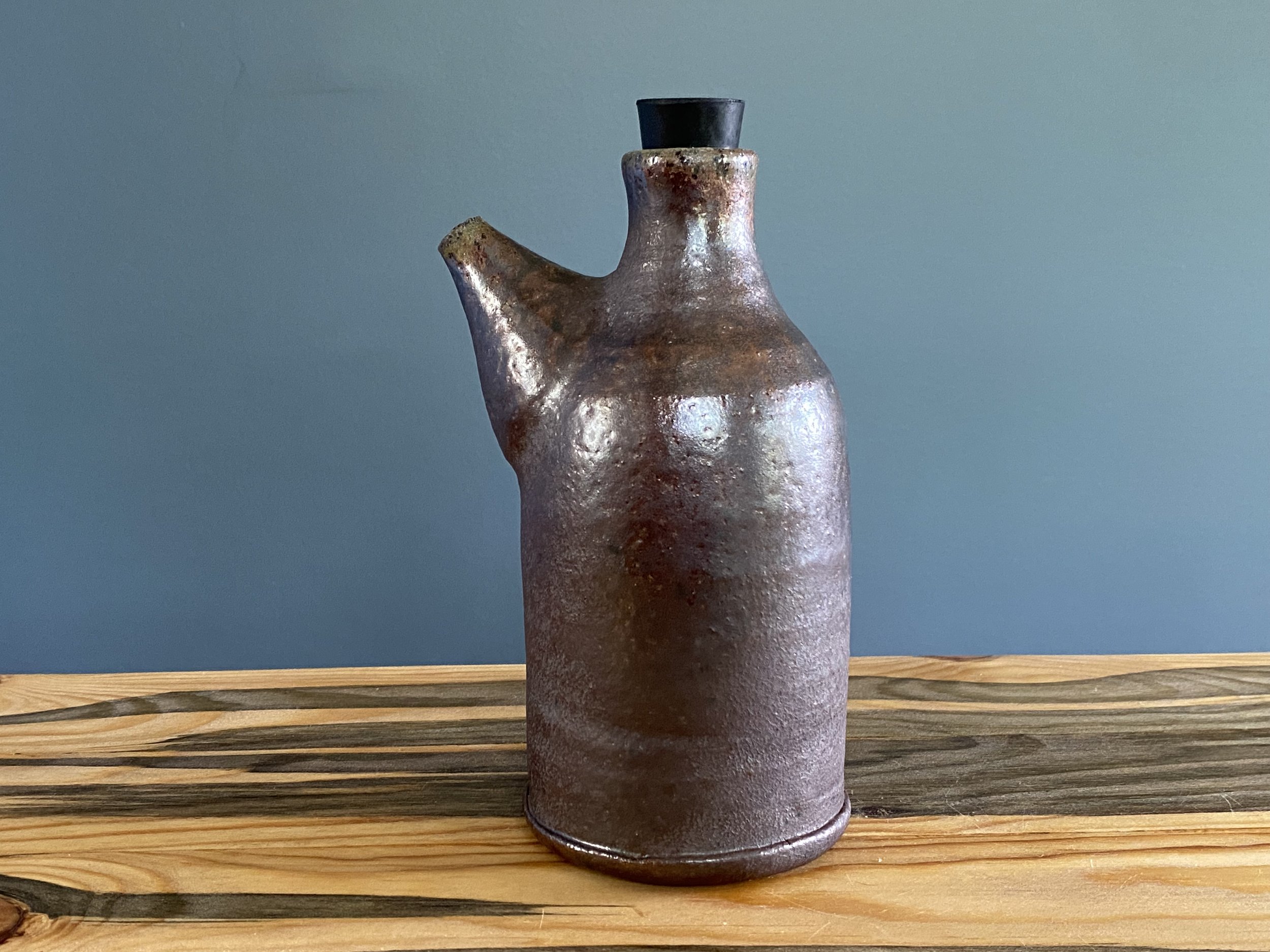 Tall oil bottle in dark stoneware