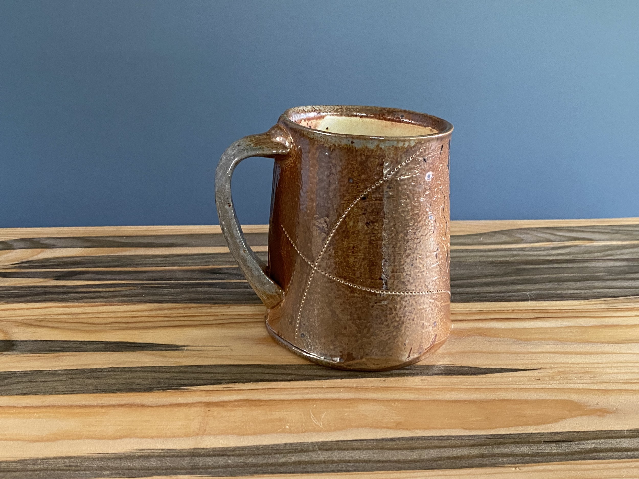 Stoneware cup with handmade monoprint transfers and stamped imagery