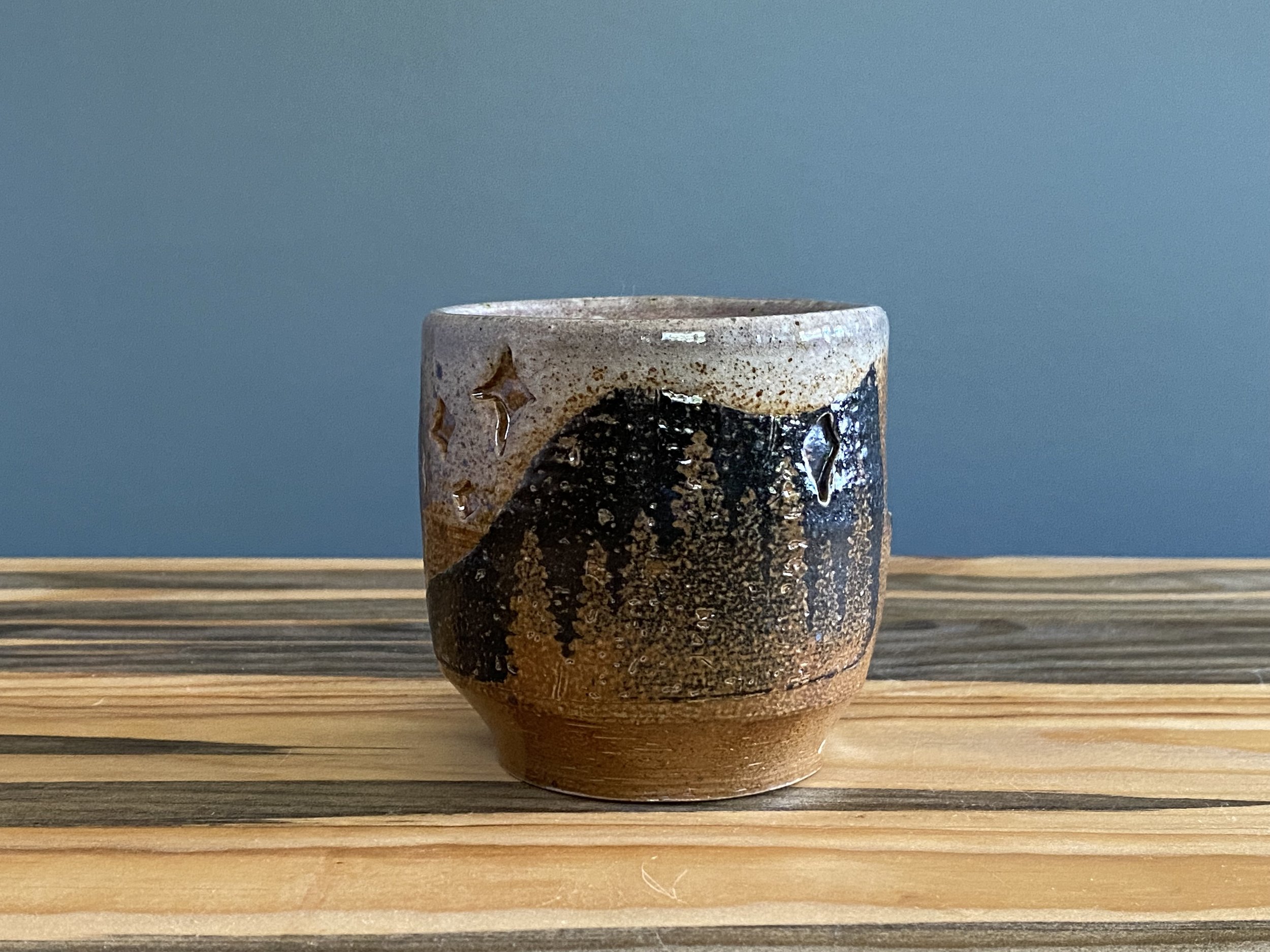 Stoneware cup with handmade monoprint transfers and stamped imagery