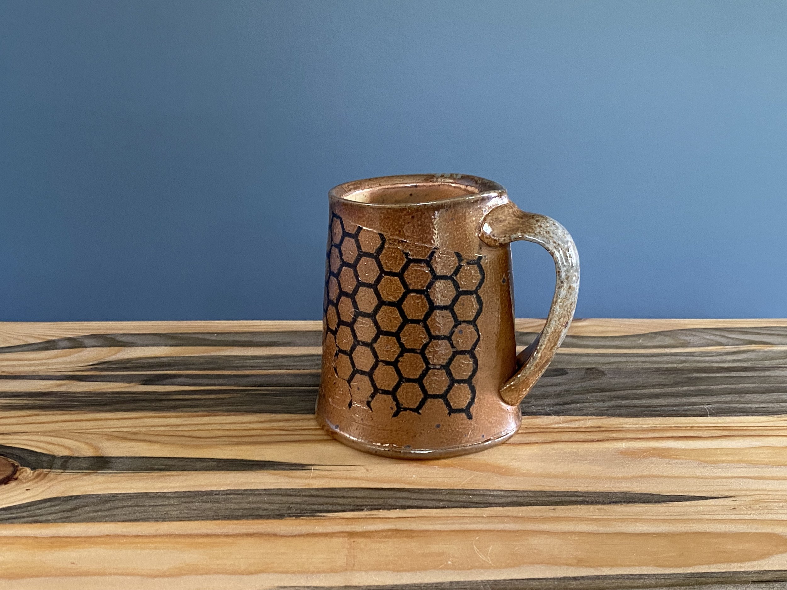 Stoneware cup with handmade monoprint transfers and stamped imagery