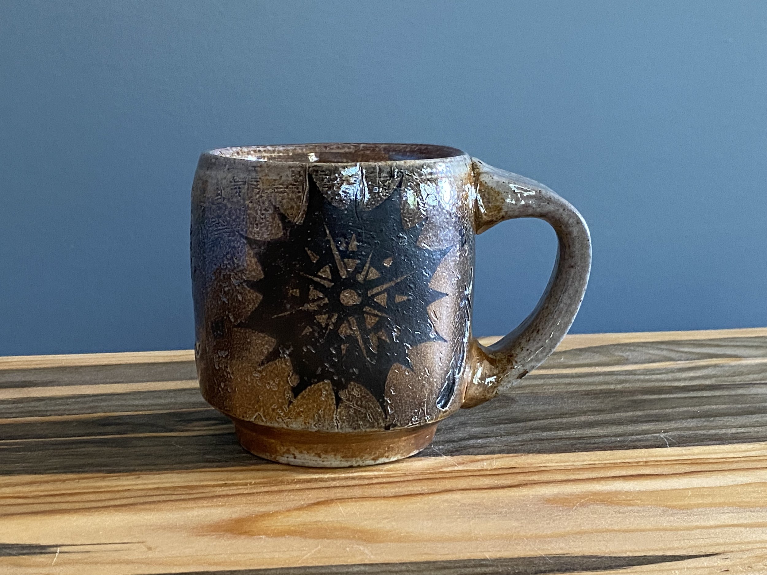Stoneware mug with handmade monoprint transfers and stamped imagery