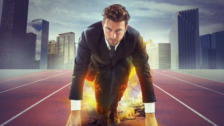 A manager in a starting position on a running track among skyscrapers – potential for development