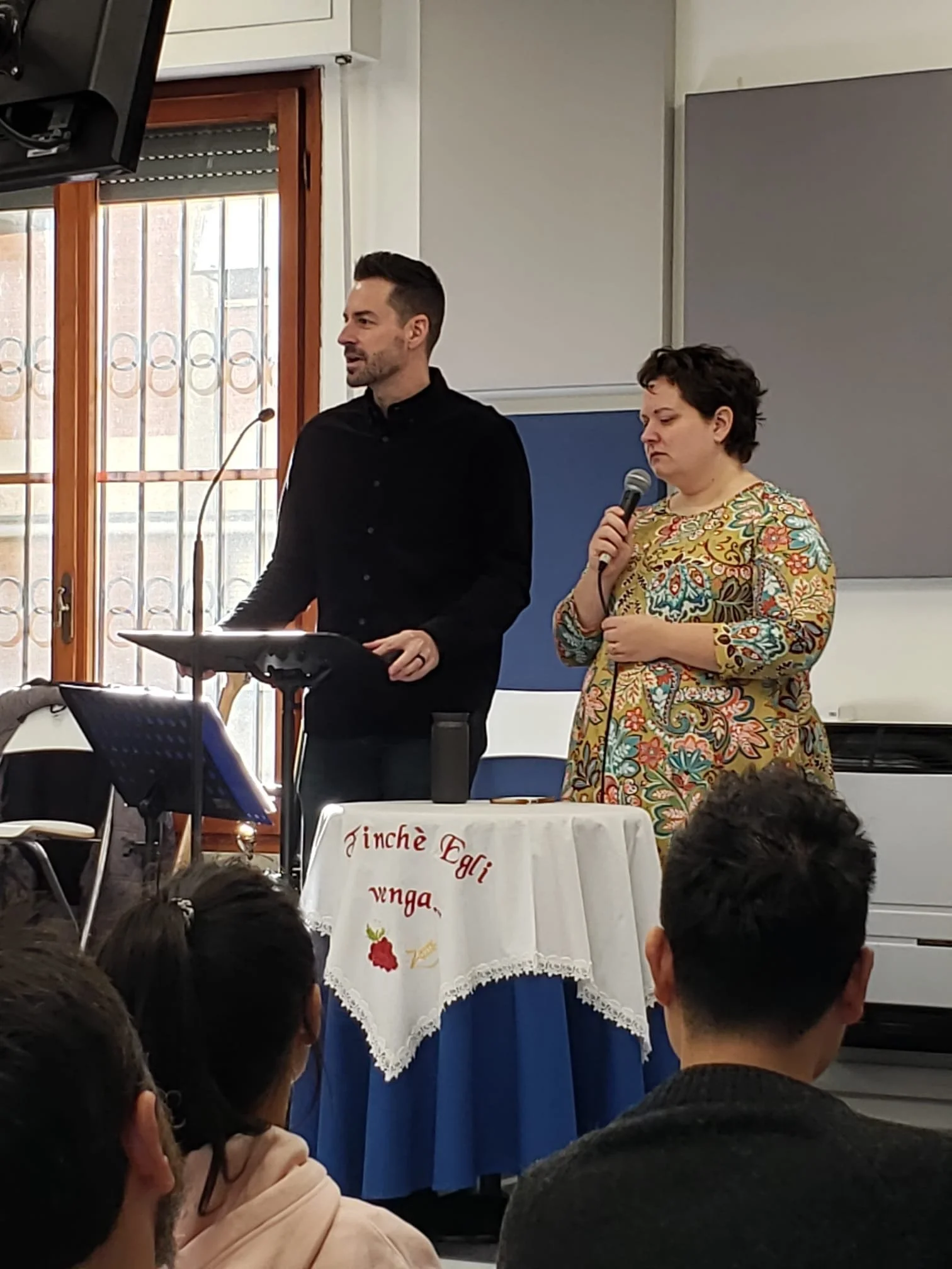 Zach preaching at the local church, with Liz translating
