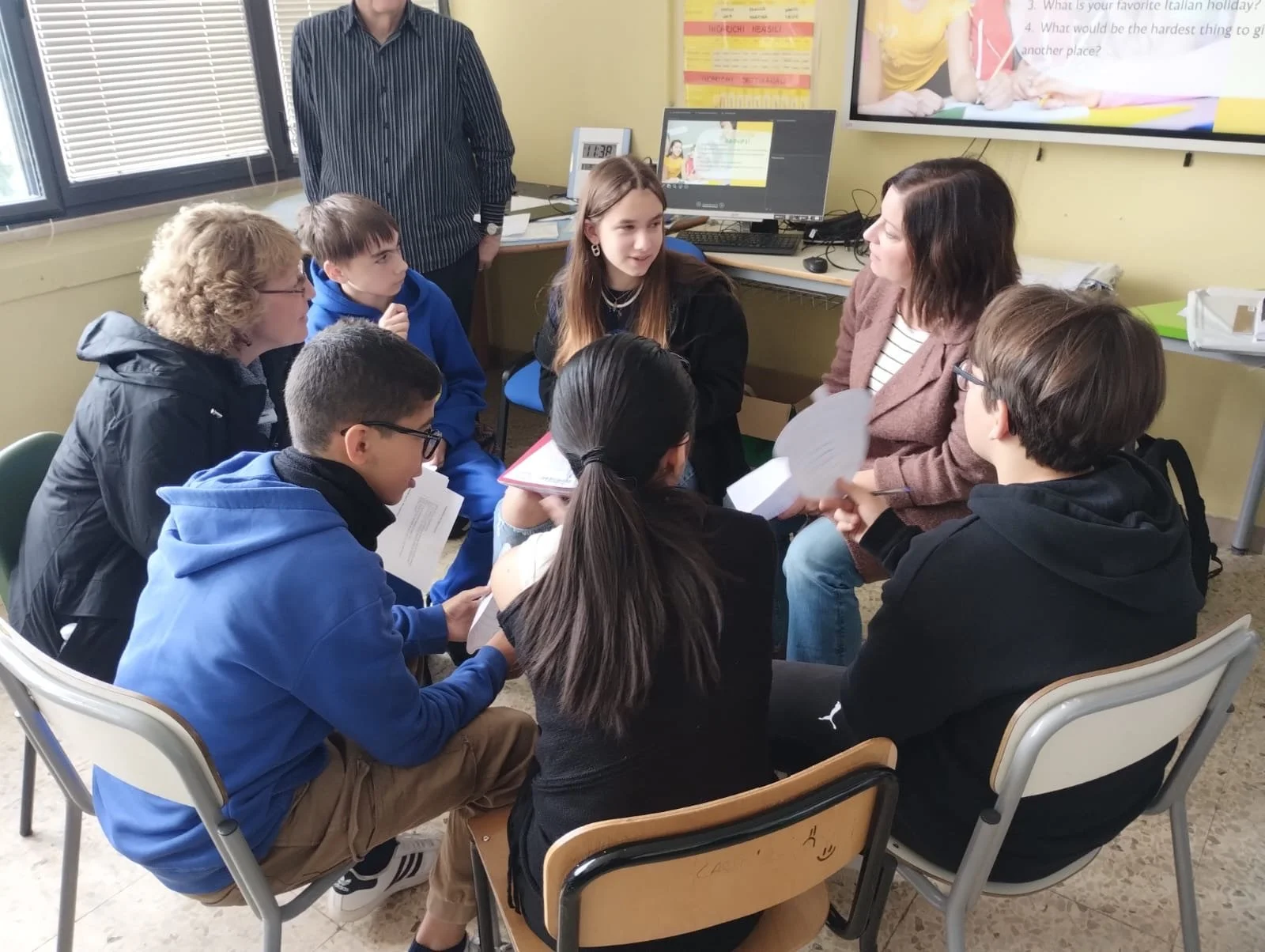 Katie leading a small group discussion in an English class