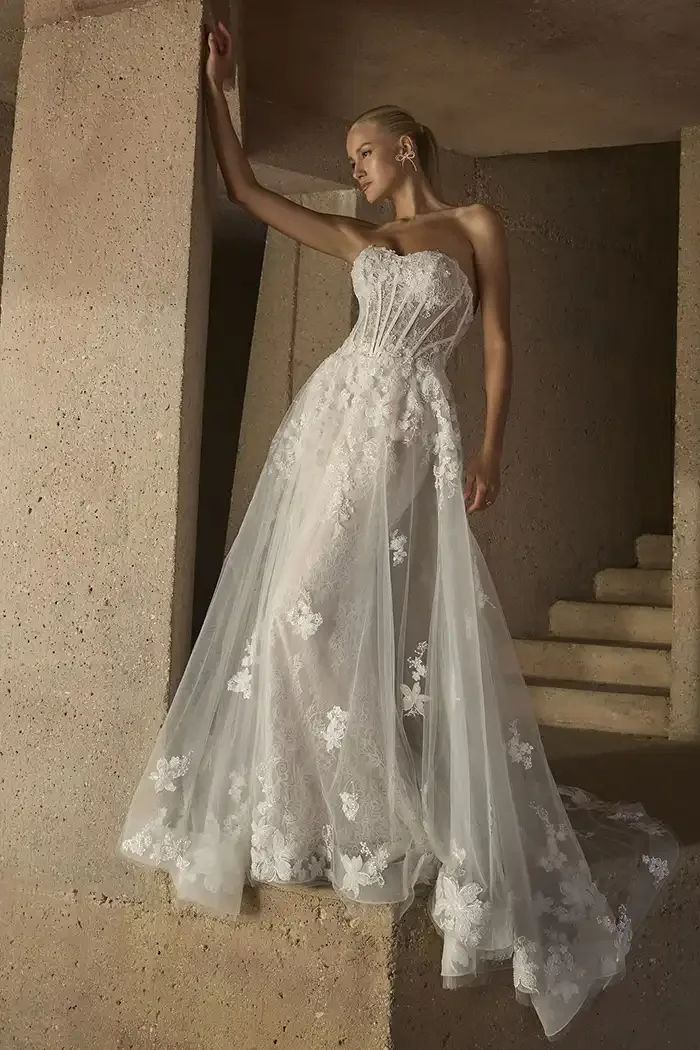 savvi-bridal-a-line-strapless-corset-boning-floral-organza-on-model-wedding-dress-raleigh.webp
