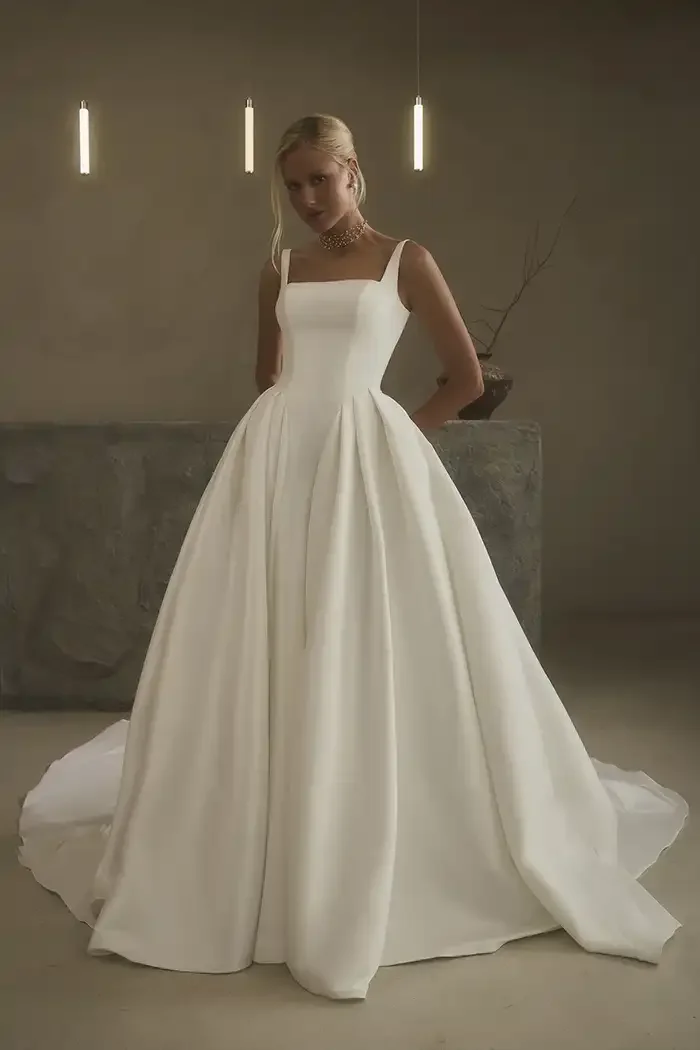 savvi-bridal-clean-satin-basque-waist-on-model-wedding-dress-raleigh.webp