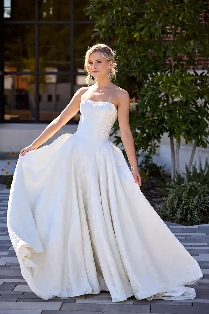 savvi-bridal-strapless-damask-basque-waist-ballgown-on-model-wedding-dress-raleigh.webp