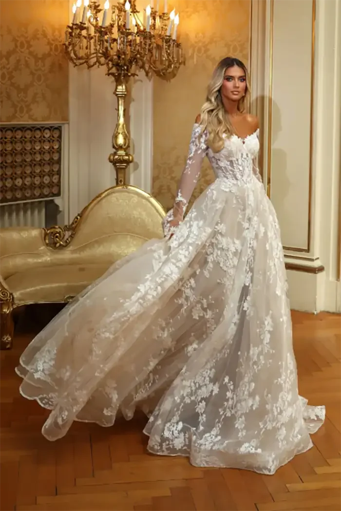 savvi-bridal-lace-a-line-long-sleeved-basque-waist-on-model-wedding-dress-raleigh.webp