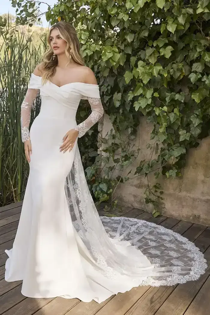 savvi-bridal-crepe-sweetheart-long-lace-sleeves-cape-veil-corset-on-model-wedding-dress-raleigh.webp