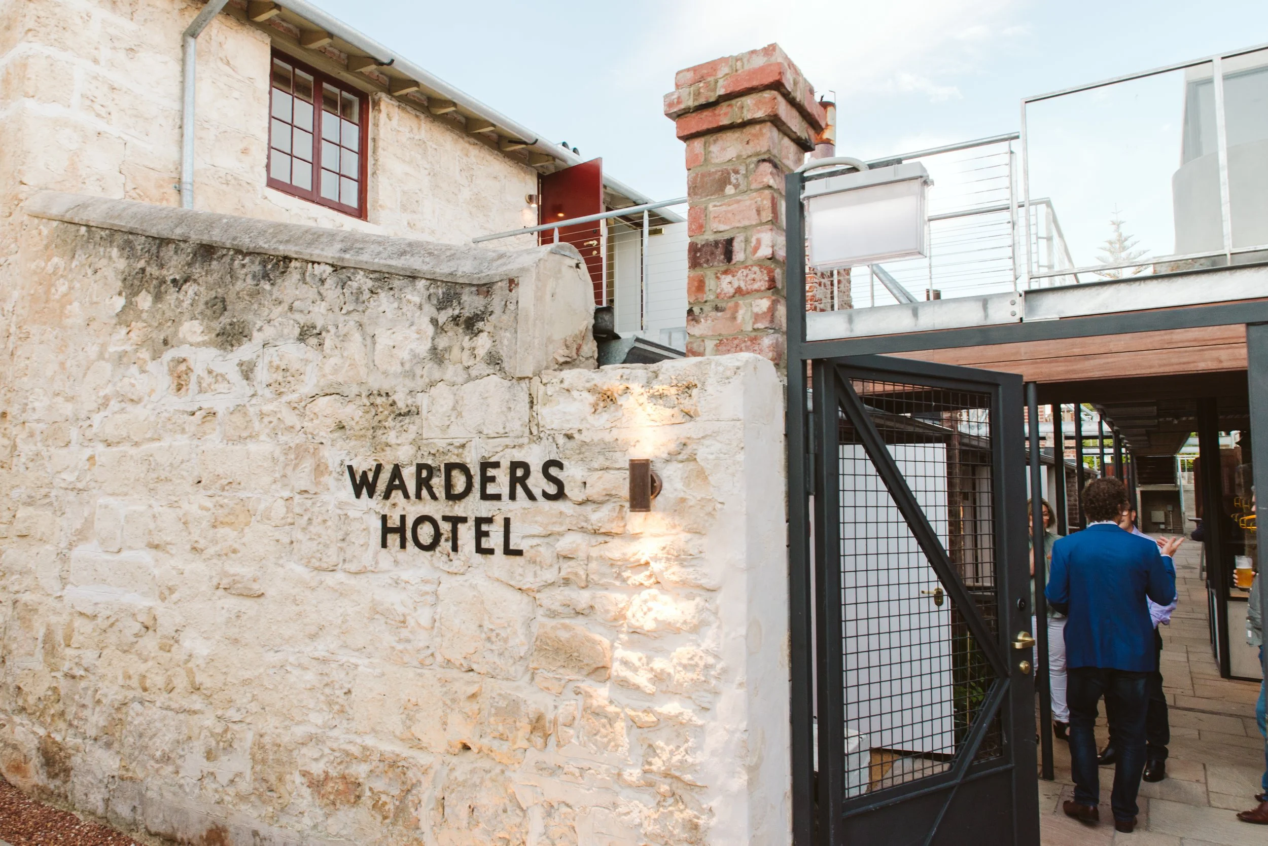 Warders Hotel limestone entrance wall and black gate