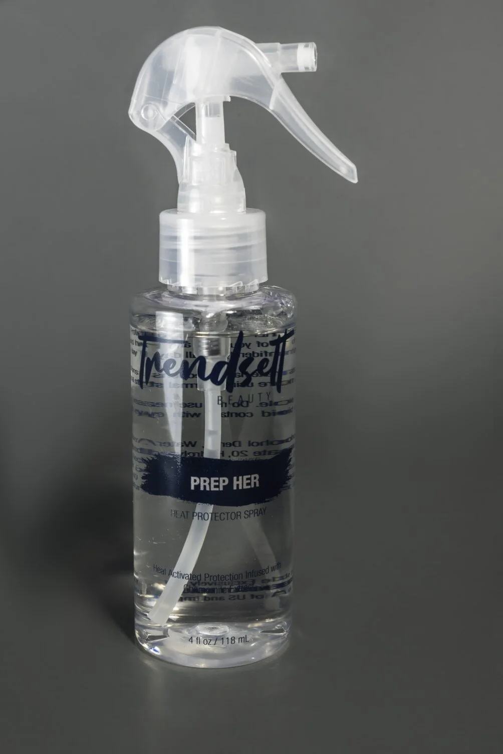 A clear spray bottle labeled "Prep Her" with a spray nozzle, containing a transparent liquid, set against a gray background.