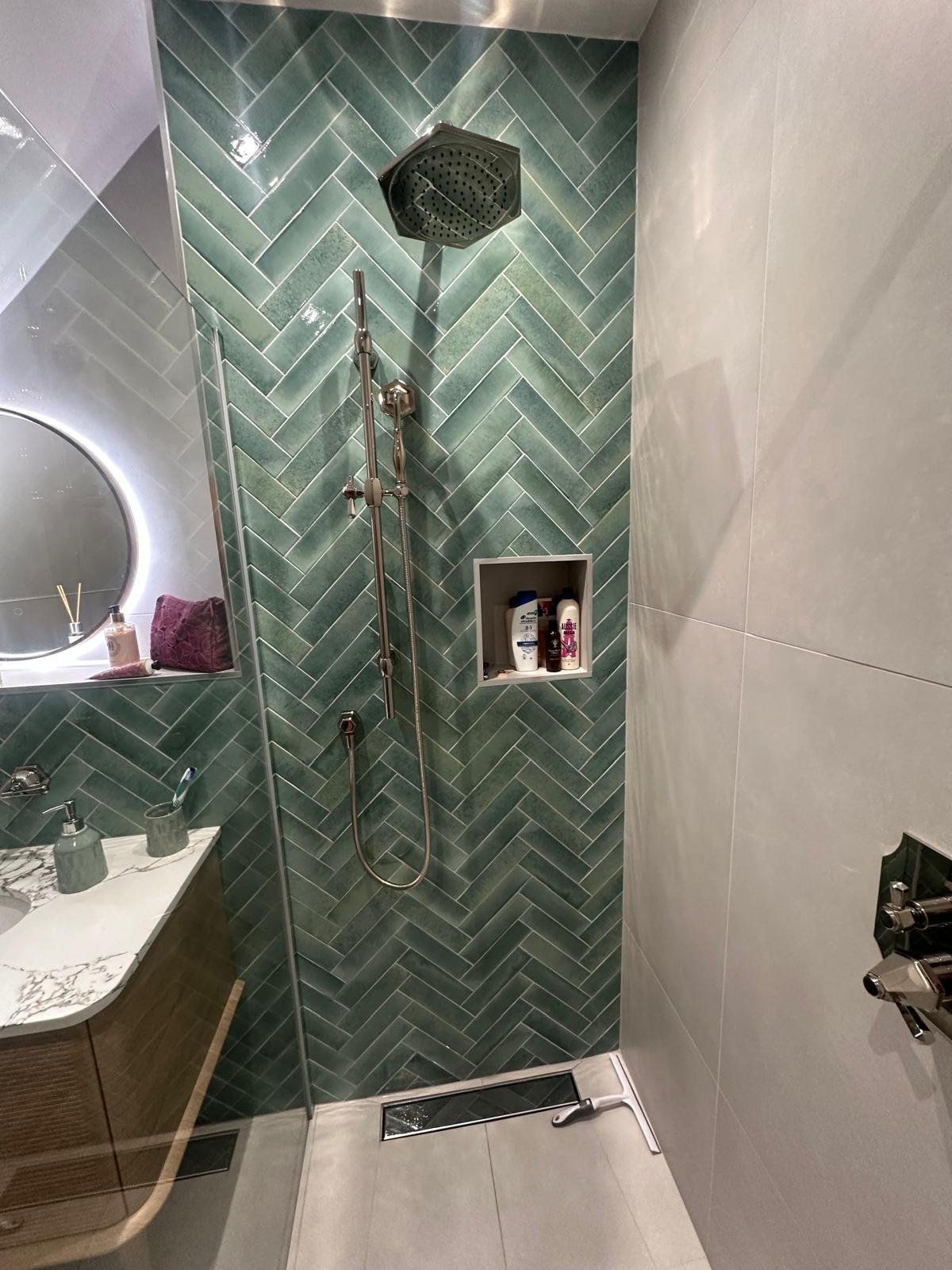 Bathrooms castle donington, bathrooms breedon, green bathroom tiles, lume tiles, turquoise tiles, feature tiles, round bathroom mirror, hib bathrooms, arbor mirror, light up mirror, smart mirror, wall hung toilet, oak vanity unit, inset sink, marble 