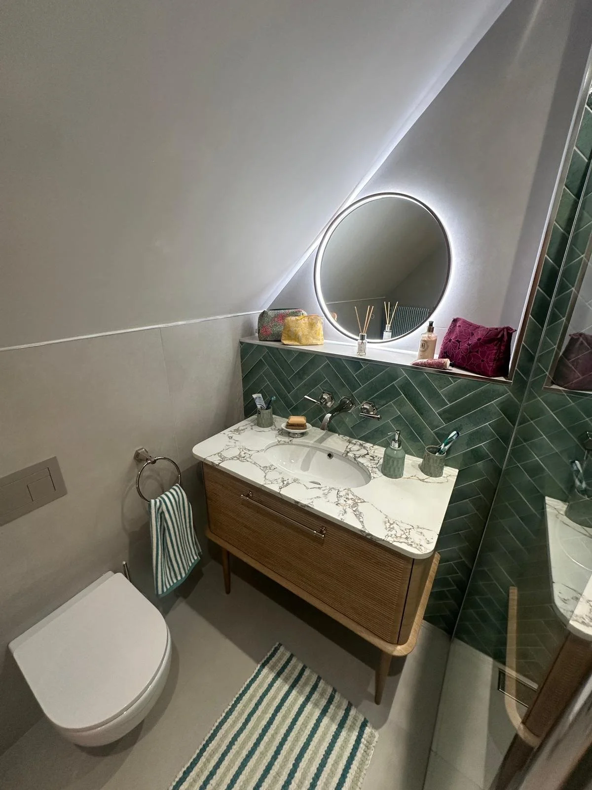 Bathrooms castle donington, bathrooms breedon, green bathroom tiles, lume tiles, turquoise tiles, feature tiles, round bathroom mirror, hib bathrooms, arbor mirror, light up mirror, smart mirror, wall hung toilet, oak vanity unit, inset sink, marble 