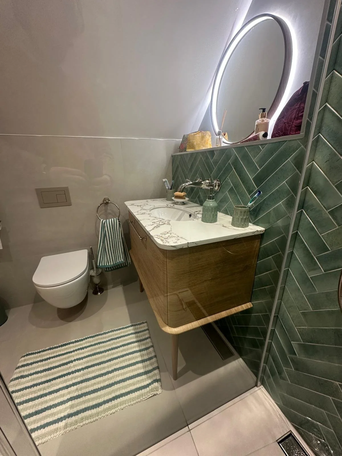 Bathrooms castle donington, bathrooms breedon, green bathroom tiles, lume tiles, turquoise tiles, feature tiles, round bathroom mirror, hib bathrooms, arbor mirror, light up mirror, smart mirror, wall hung toilet, oak vanity unit, inset sink, marble 