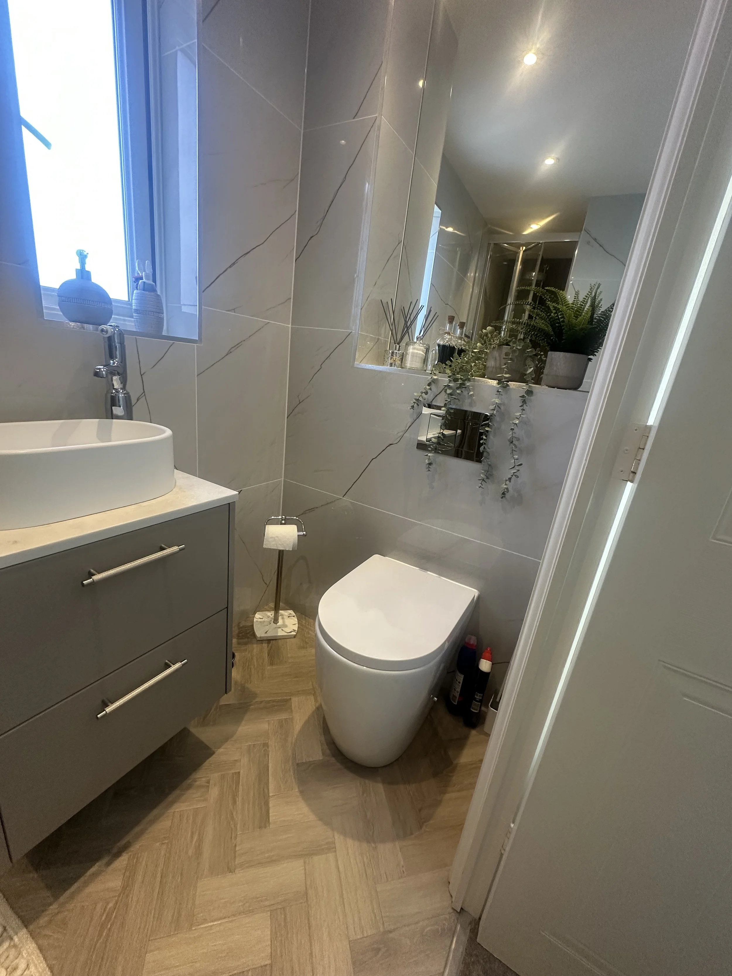 Calypso fitted furniture basalt mist brecon gunmetal romy sit on basin hib tece penelope gunmetal house of Piccadilly double ended bath amtico form keel oak rivoli feature tile lines tile inka gunmtal towel warmer wendover chrome radiator burlington