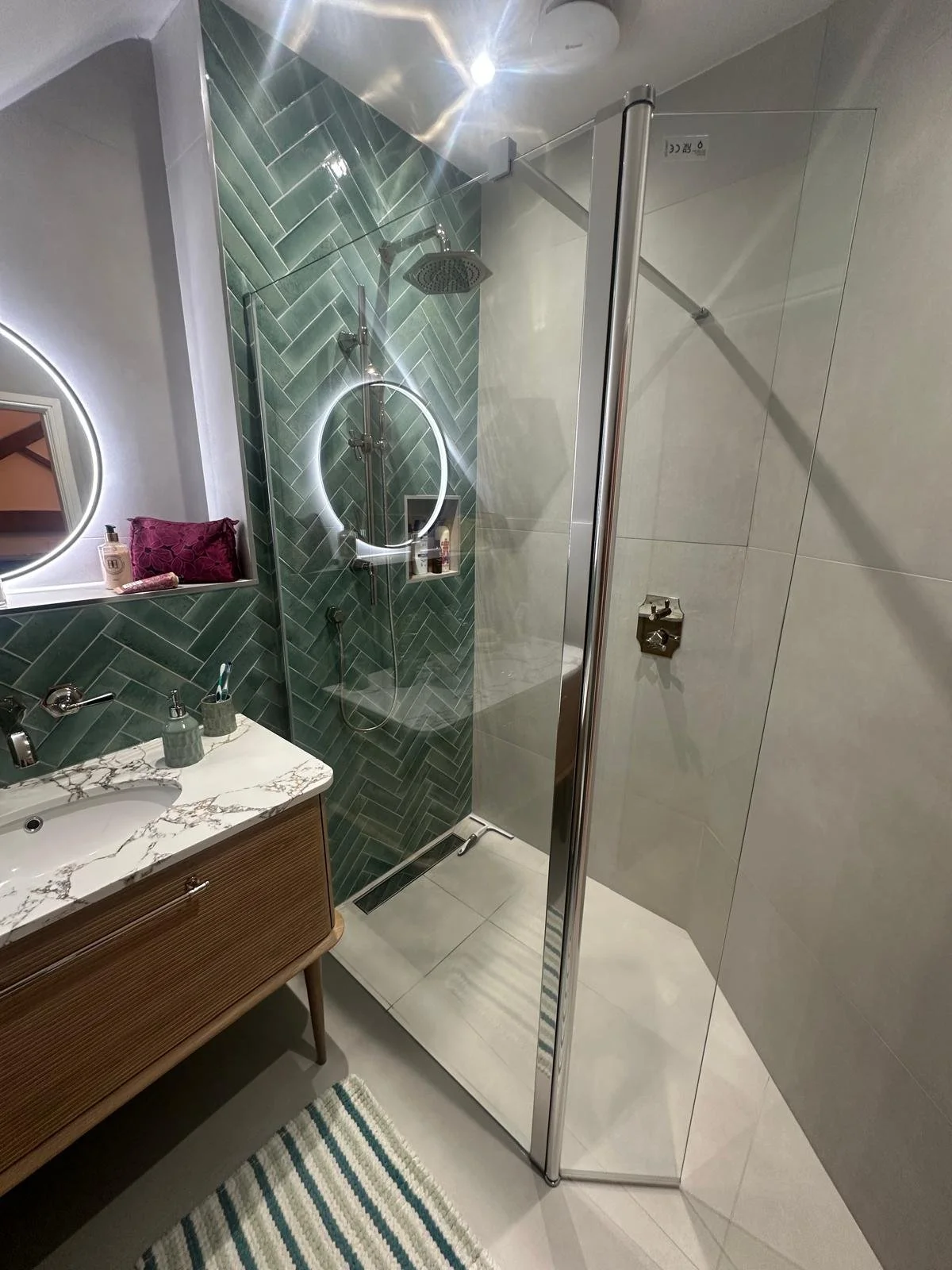 Bathrooms castle donington, bathrooms breedon, green bathroom tiles, lume tiles, turquoise tiles, feature tiles, round bathroom mirror, hib bathrooms, arbor mirror, light up mirror, smart mirror, wall hung toilet, oak vanity unit, inset sink, marble 