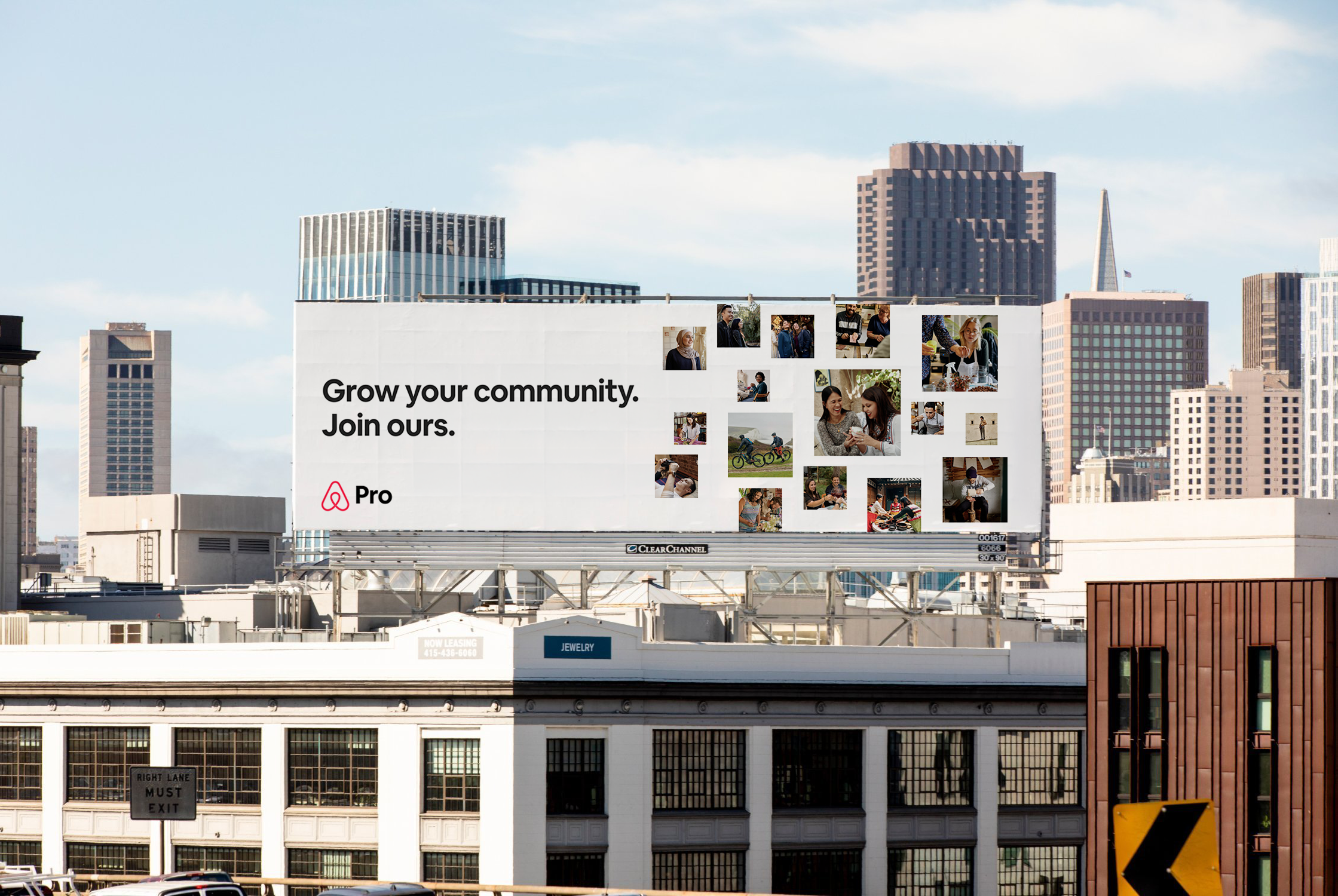 A large billboard on a city building displays a message encouraging community growth and joining a community platform, featuring several photos of diverse people engaging in various activities. The skyline includes tall modern skyscrapers and the Transamerica Pyramid, indicating San Francisco.