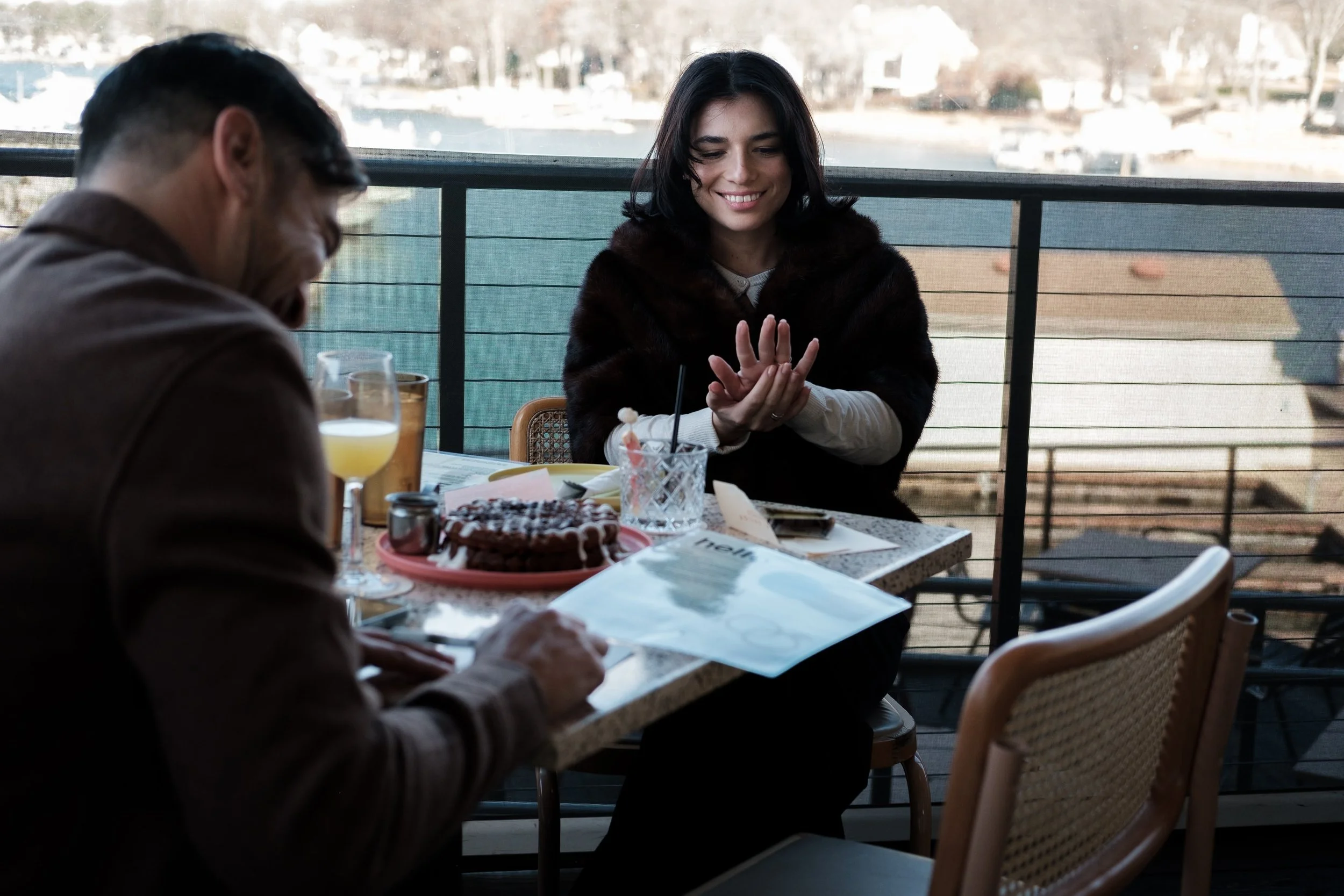 girl admires her ring after engagement by documentary wedding photographer Brandon Pickett