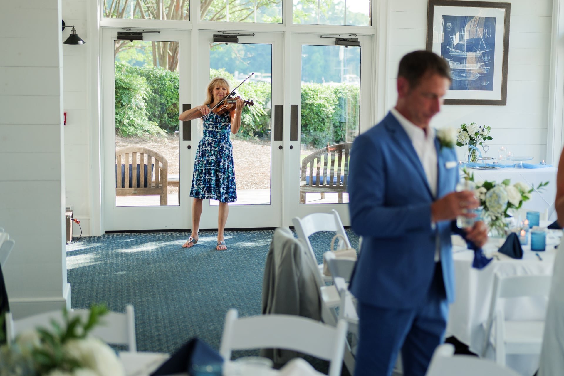 woman playing violin during wedding ceremony at Safe Harbor Peninsula venue, by Brandon Pickett Photography