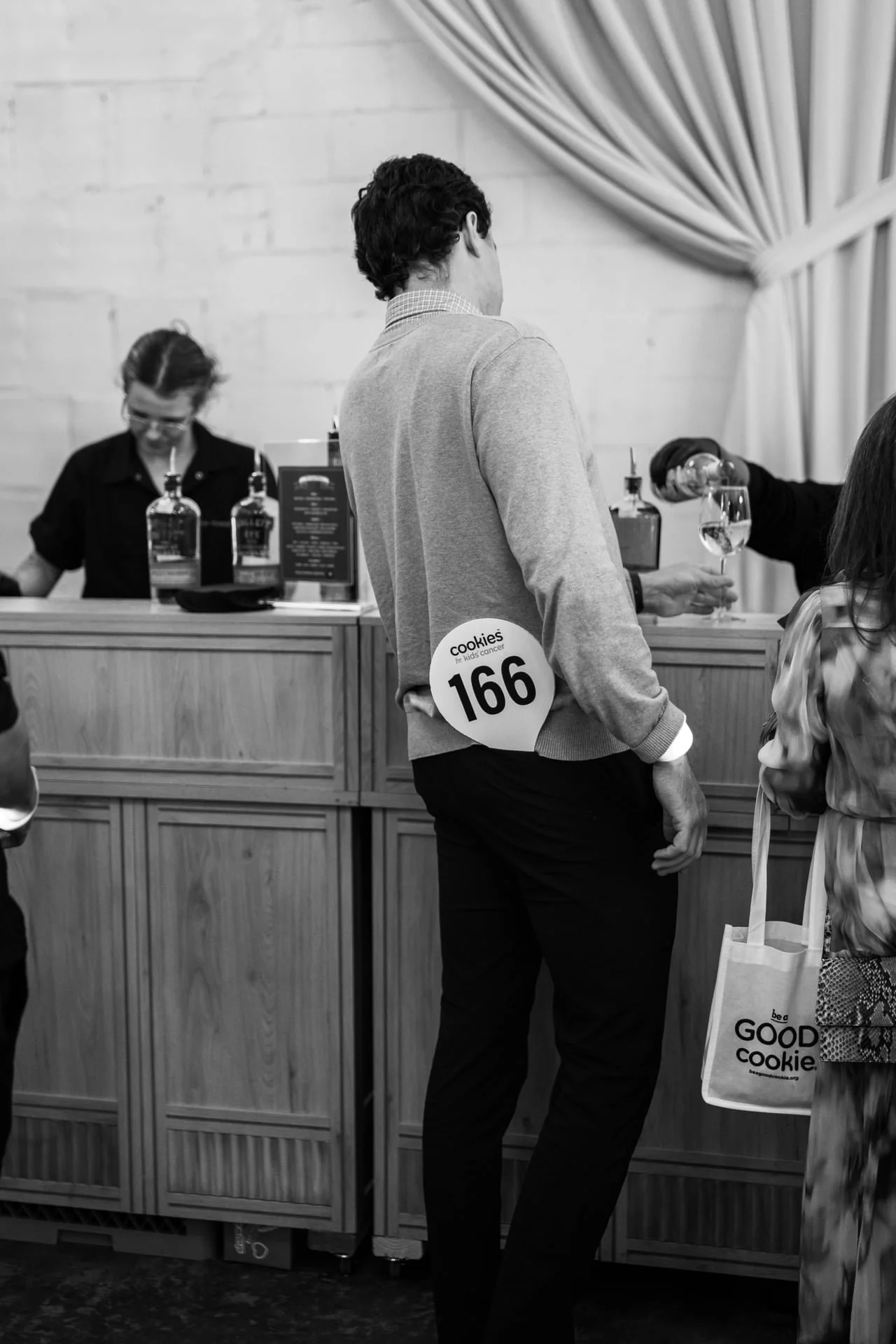 paddle for auction sticking out of mans back pocket at The Casey. By Charlotte photographer, Brandon Pickett