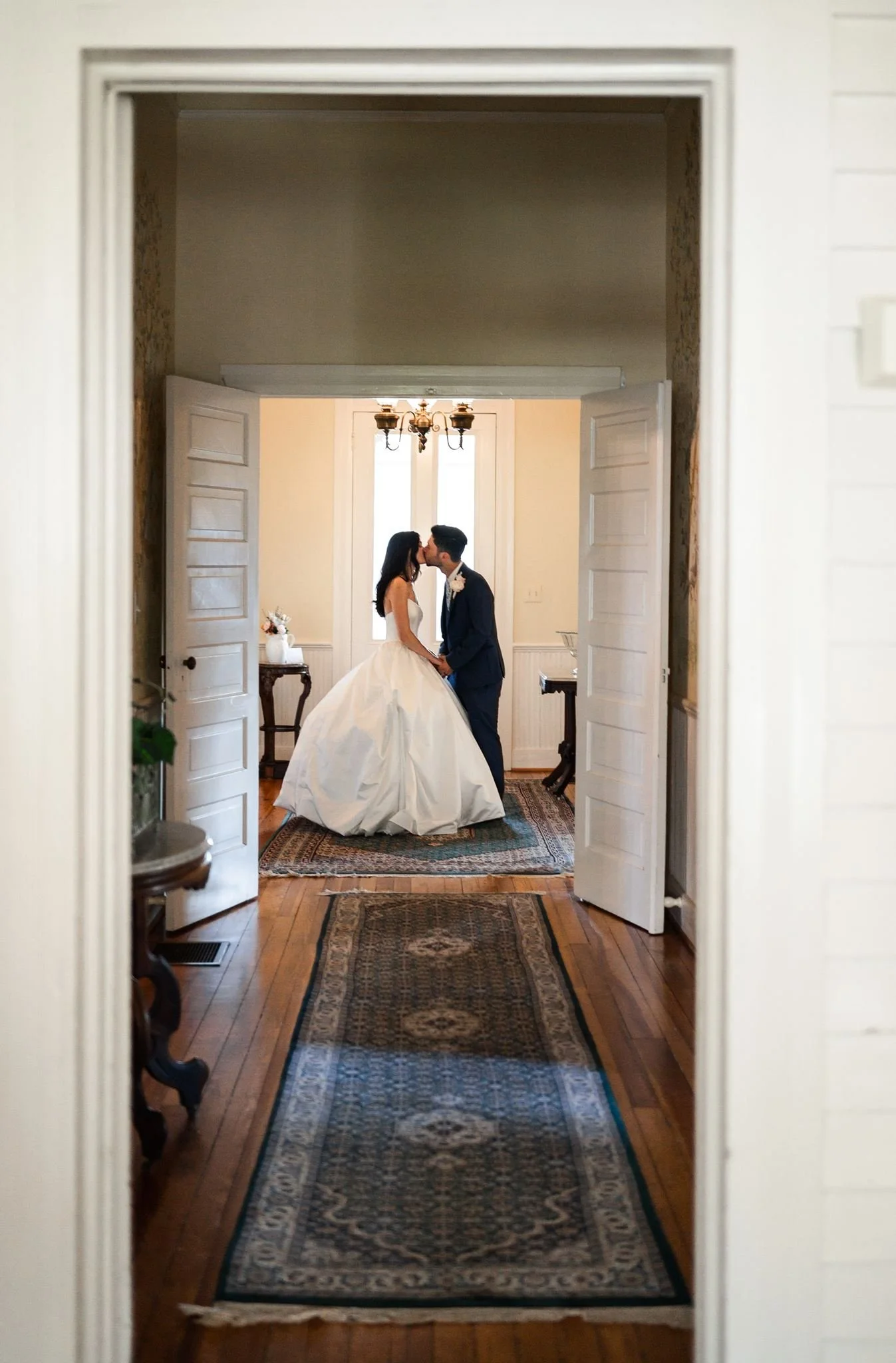 Bride and groom kissing portrait inside Reid House in Mathews, NC.