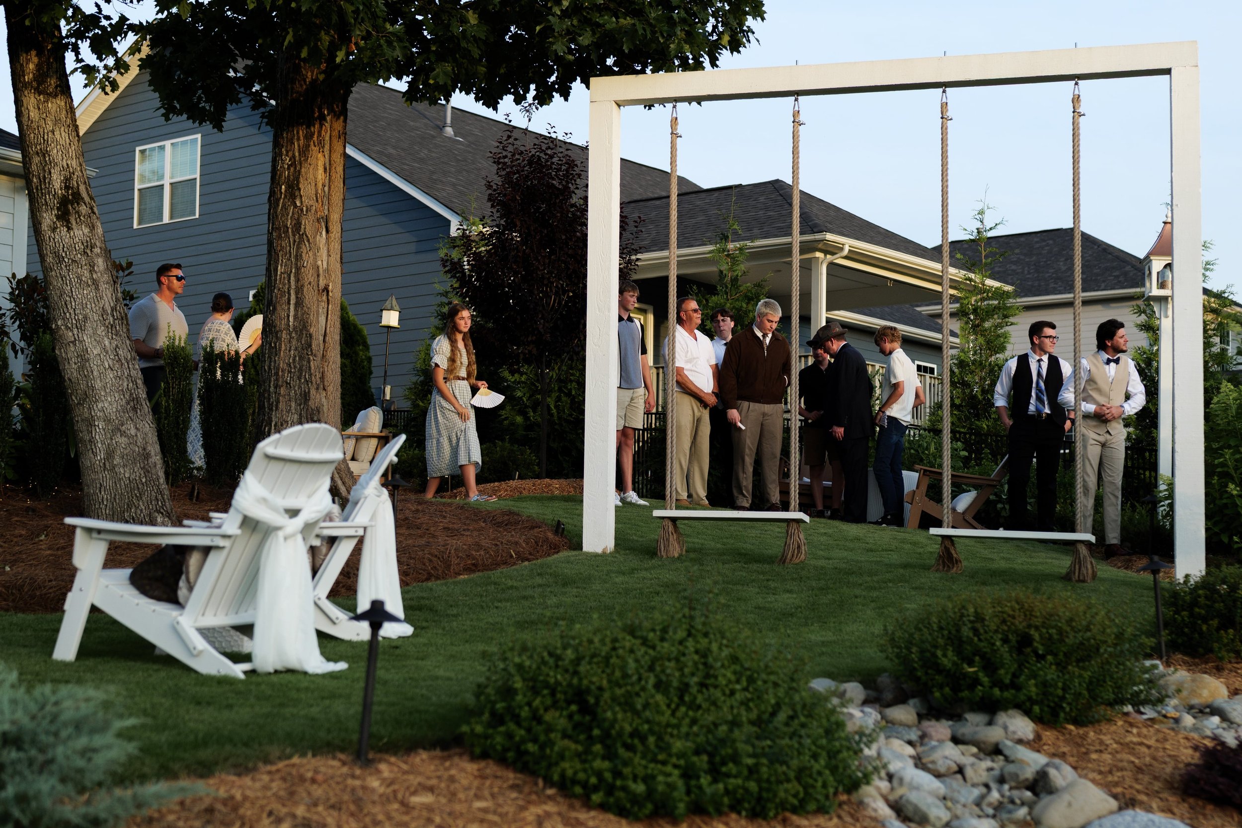 Wedding guests at intimate backyard wedding in Charlotte, waiting for bride and groom to arrive