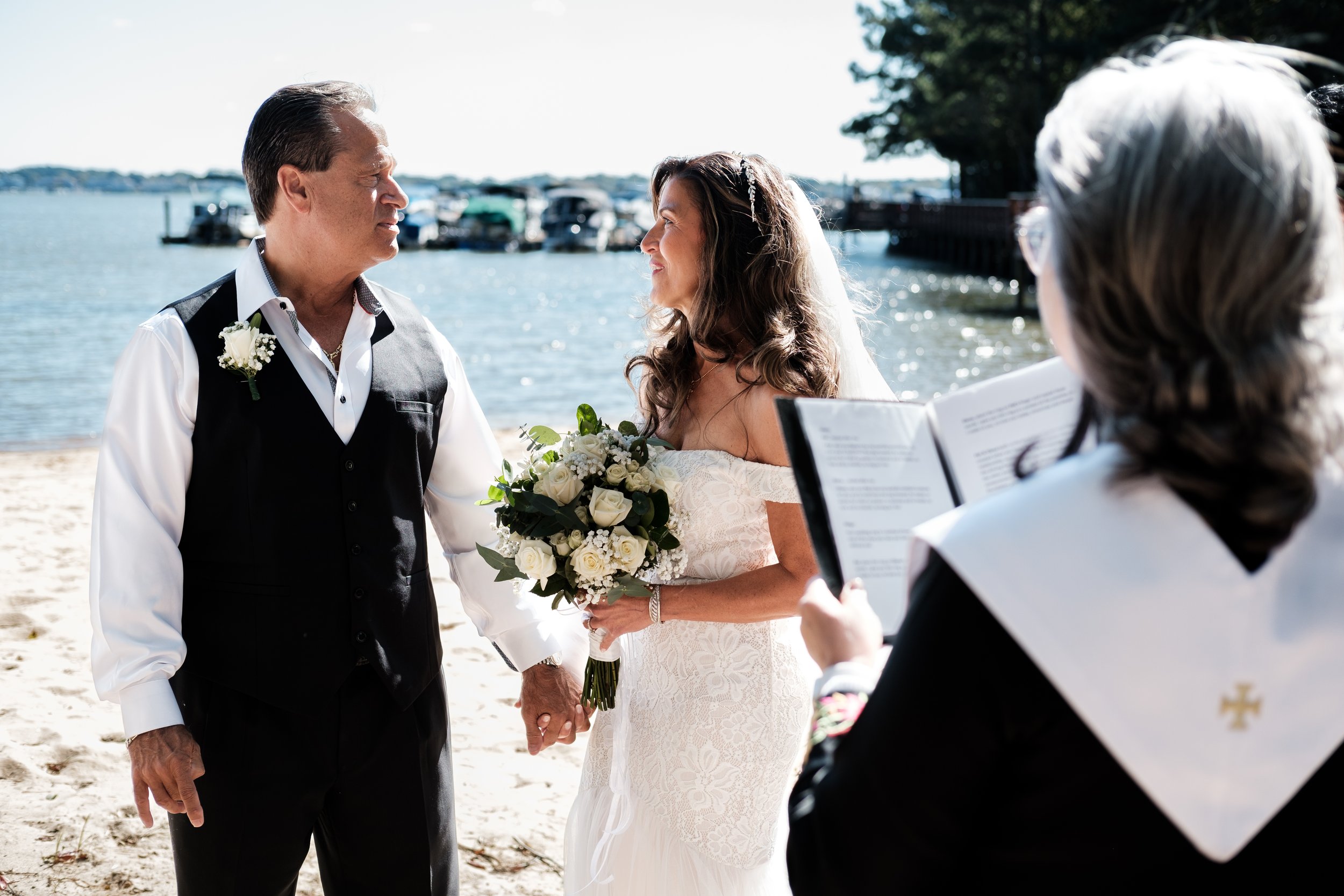 Older Bride and Groom looking at each other during beach wedding at Lake Norman, NC