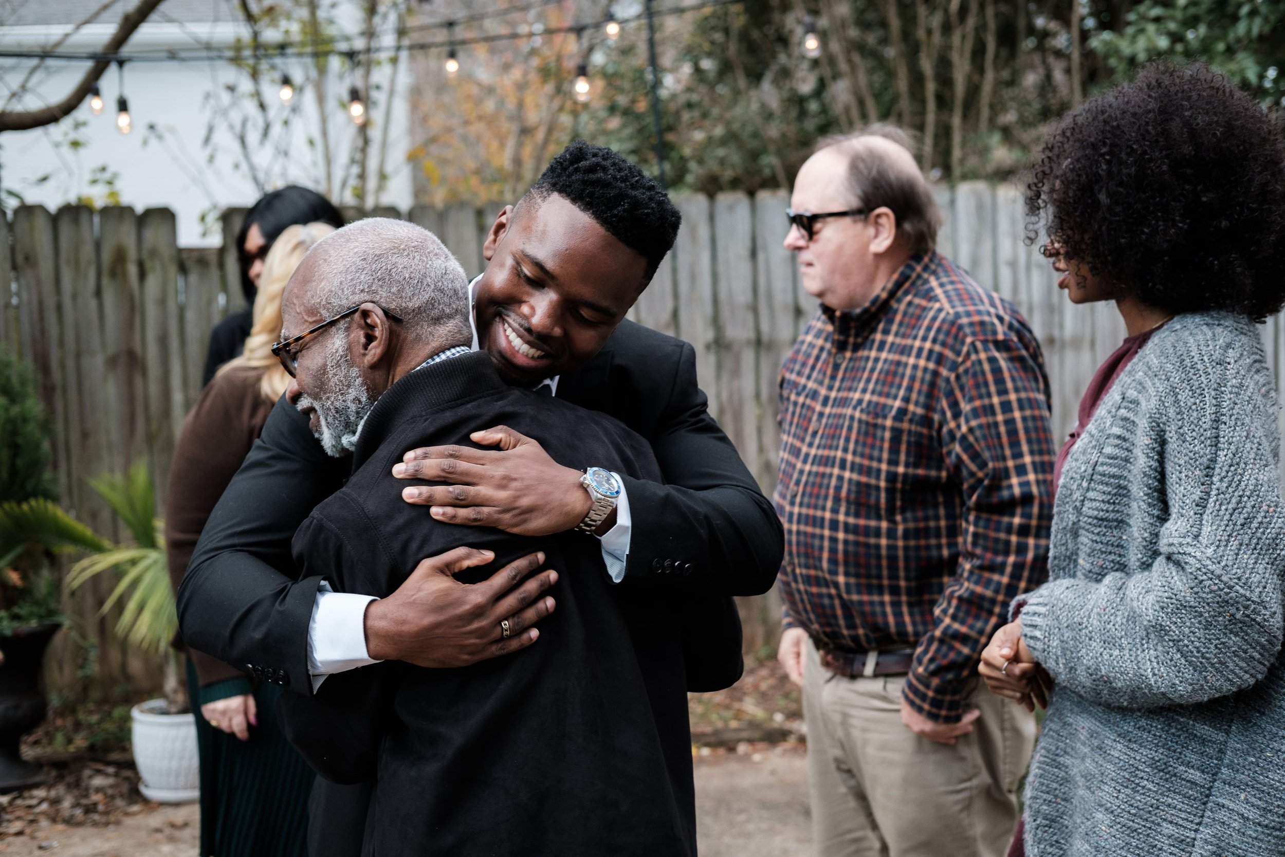 groom hugging his father after just getting married in Charlotte, NC