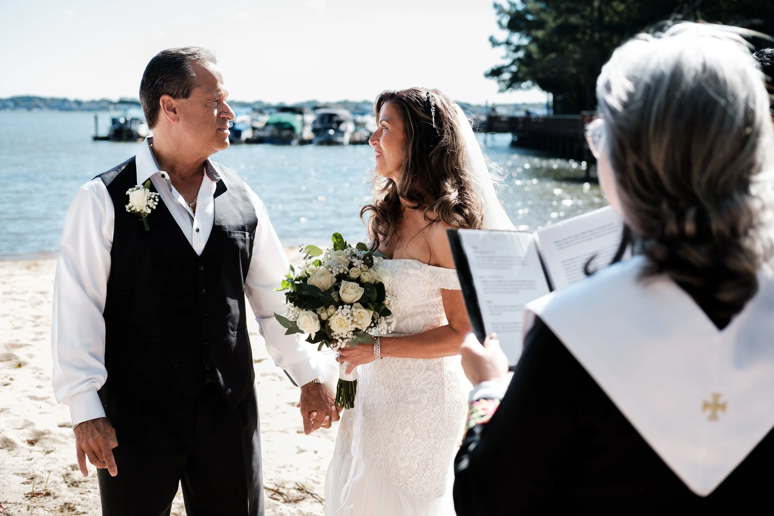 Older bride and groom looking at eachother during beach lake wedding at Lake Norman, NC