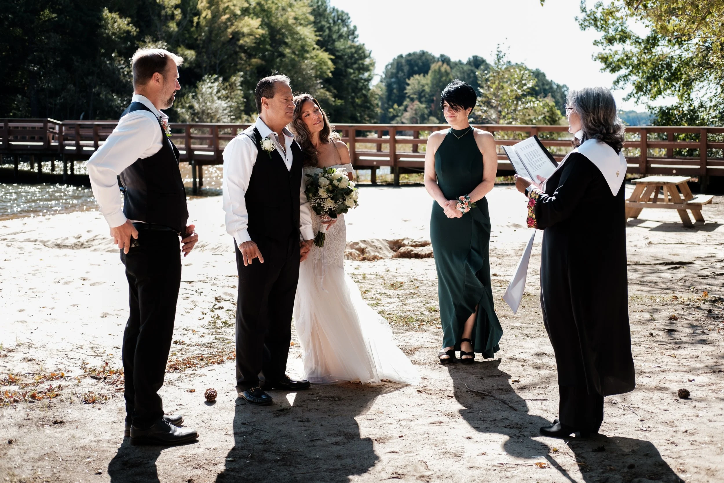 Wedding ceremony on a beach with couples and officiant during a beach wedding on Lake Norman, North Carolina