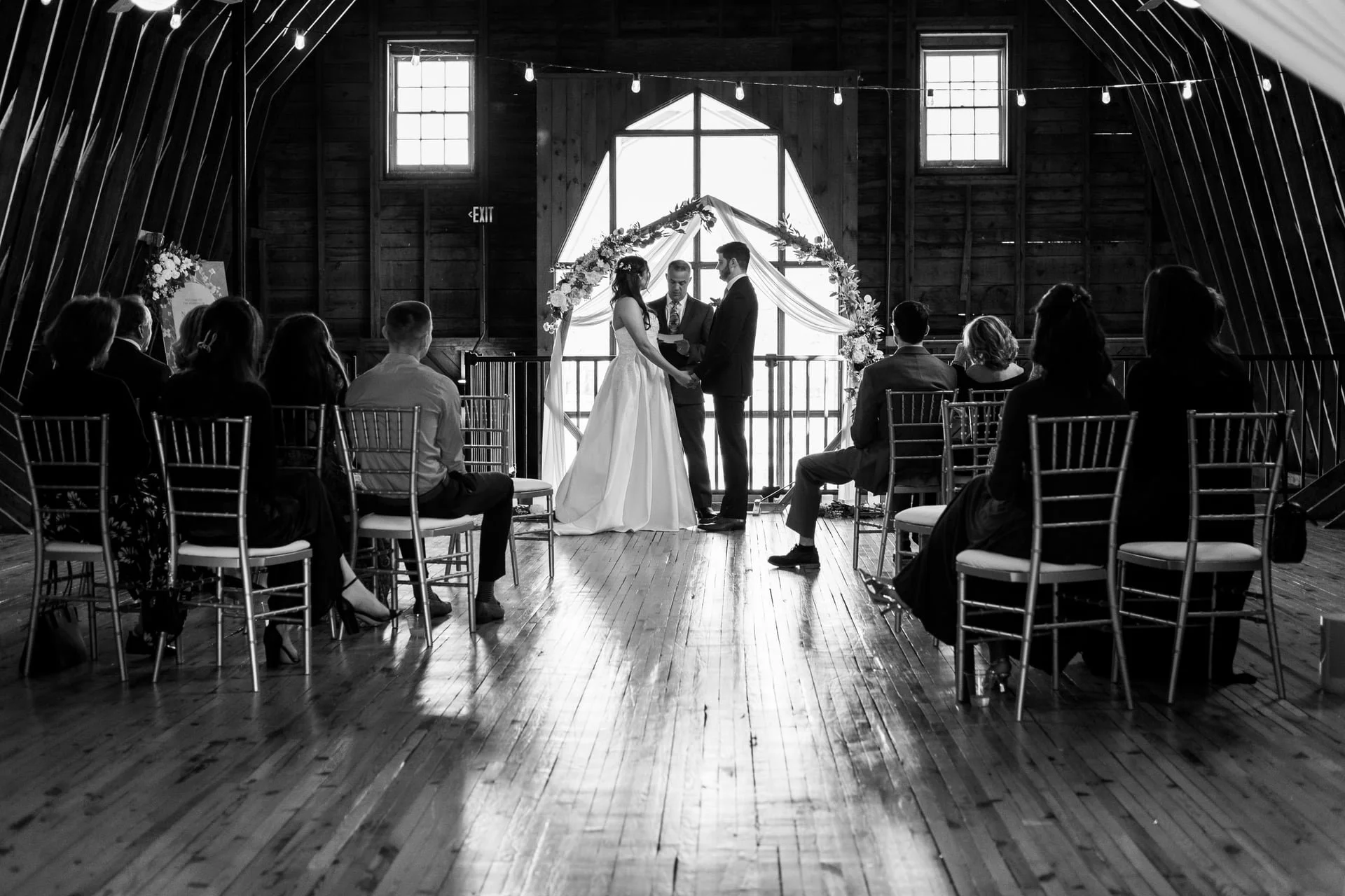 wide shot of wedding ceremony in the loft at Founders Dairy Barn wedding venue from Brandon Pickett Photography