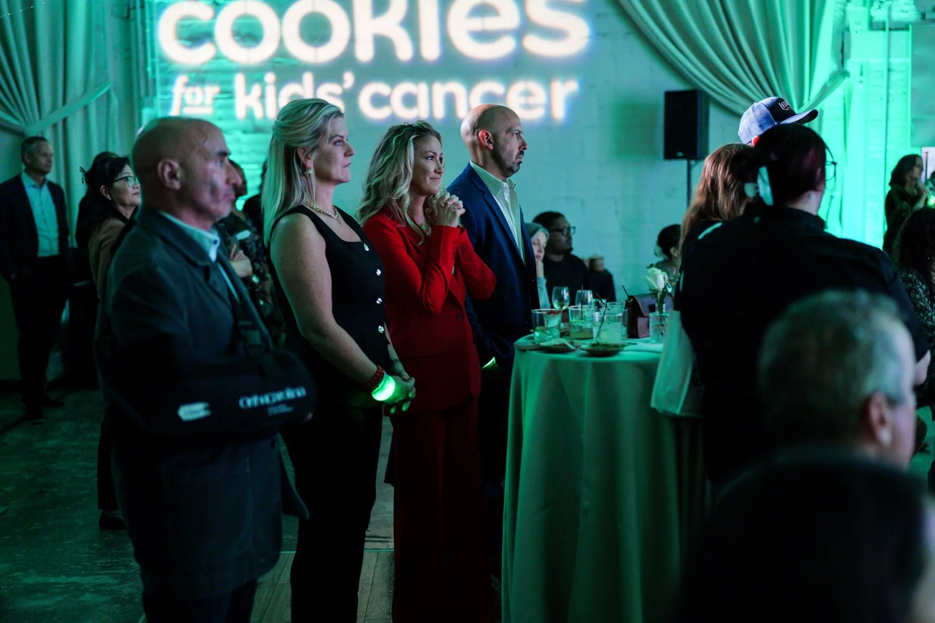 crowd listening during a heartfelt speech at cookies for kids cancer event in Charlotte.