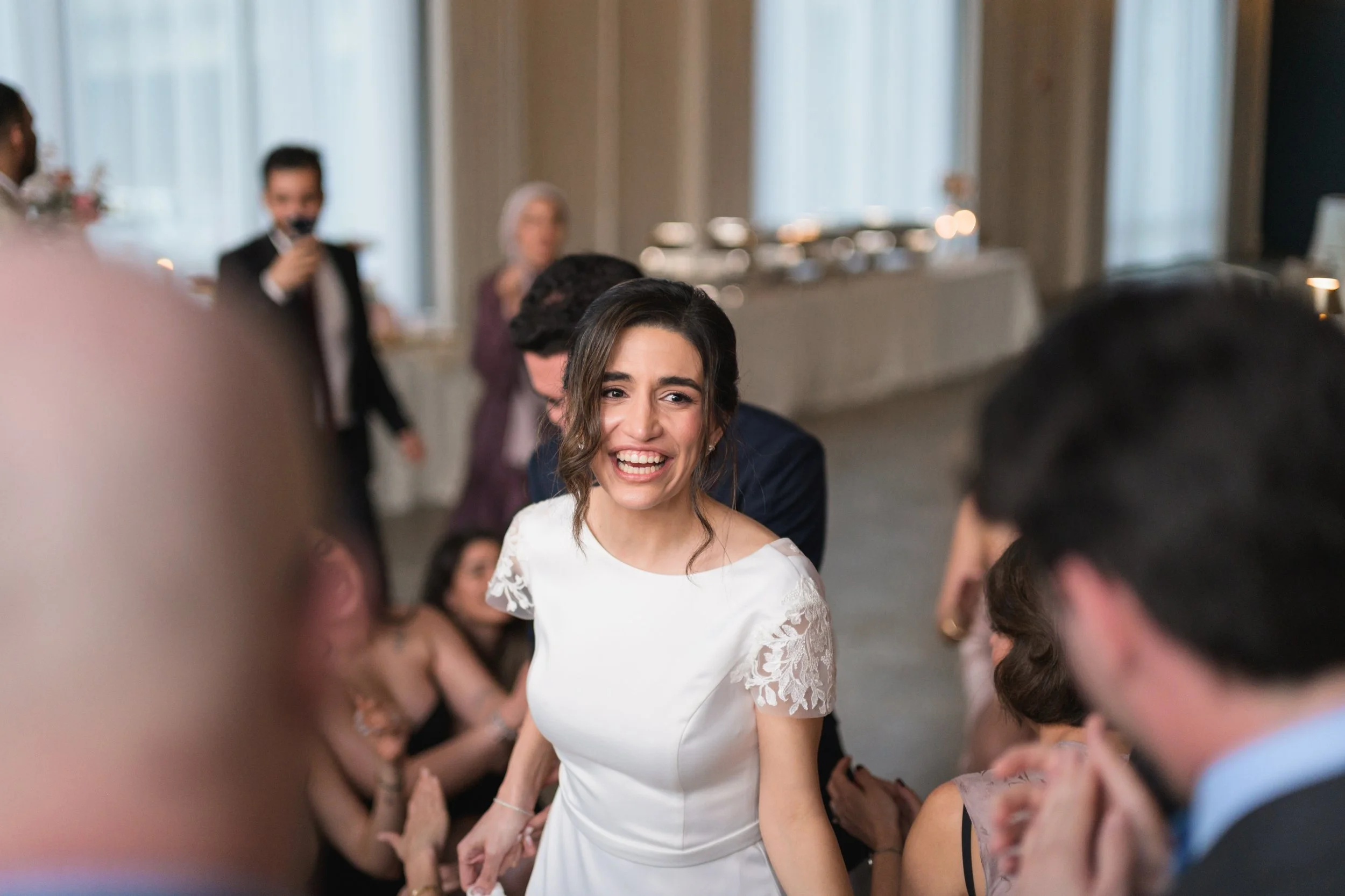 bride in white dress smiling while on the dance floor at Pine wedding venue in Charlotte.